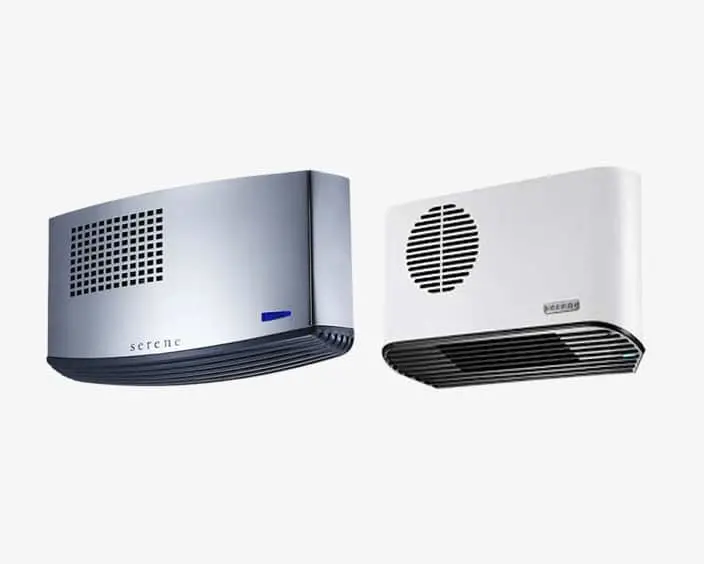 Two wall-mounted air heaters, one gray and one white, with ventilation grilles on their front panels.