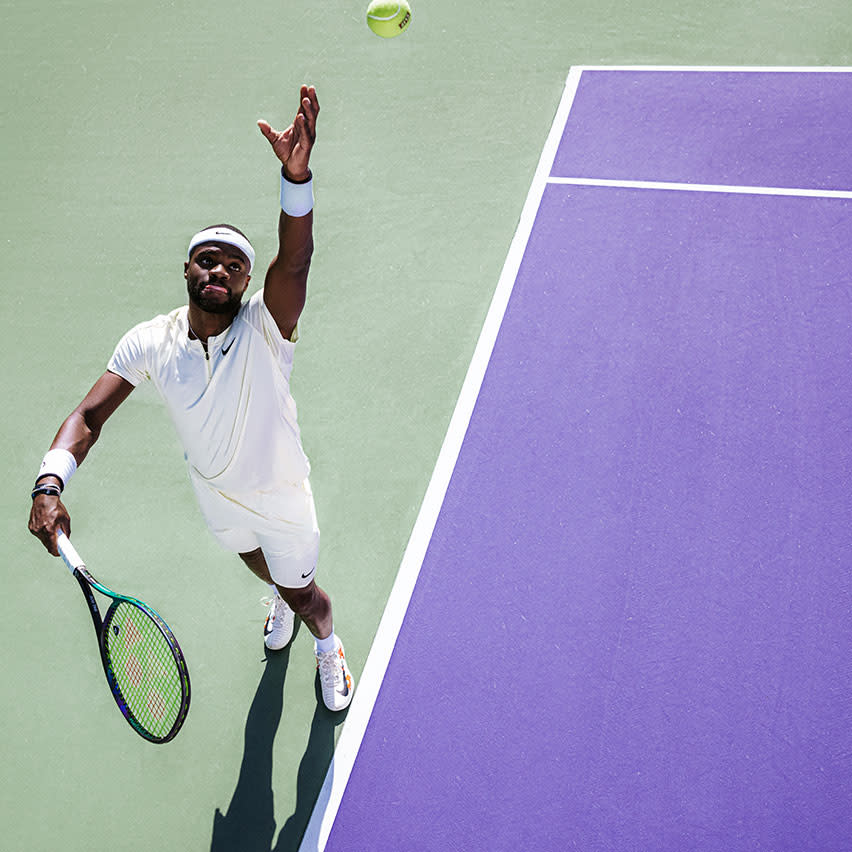 Frances Tiafoe serving on tennis court listing