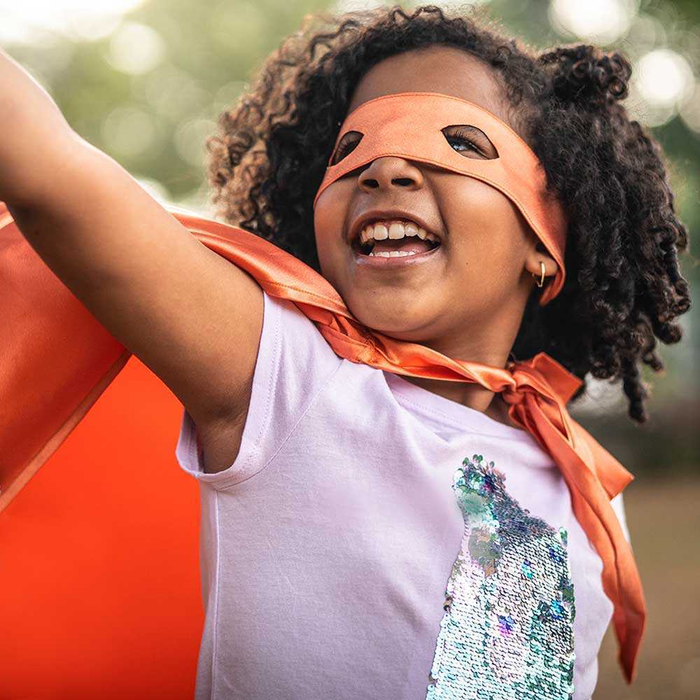 Girl in cape and mask