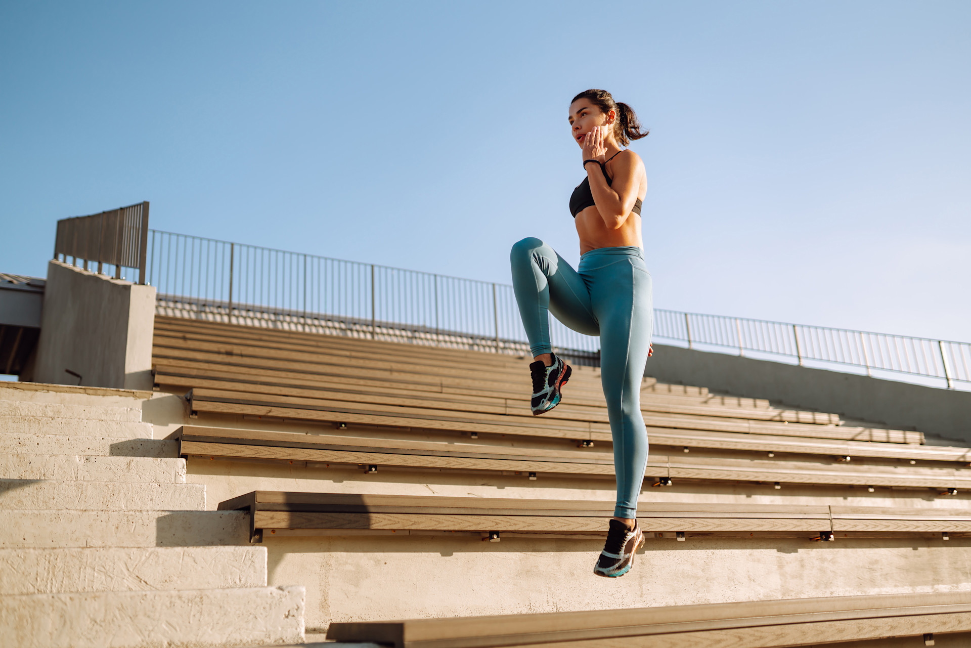 BUILDERS Protein featured card. A woman doing high knee jumps on stairs.