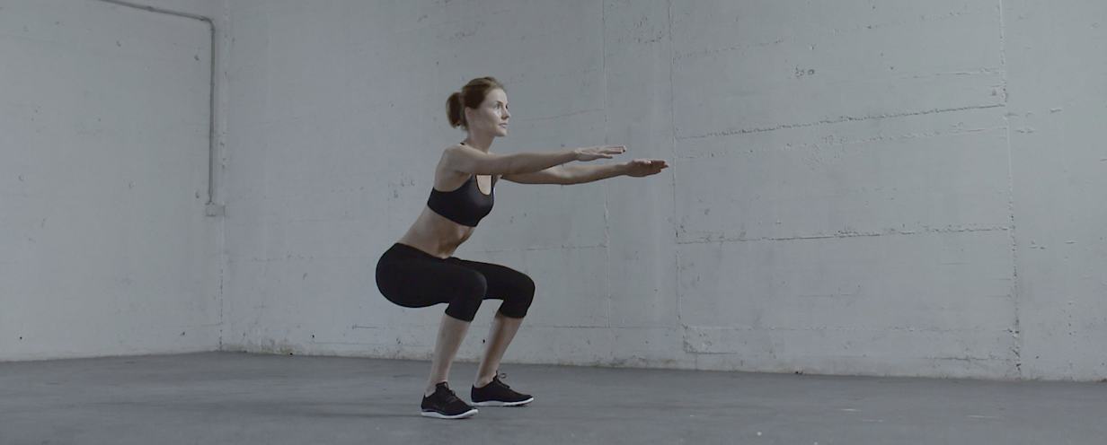 the woman doing a squat