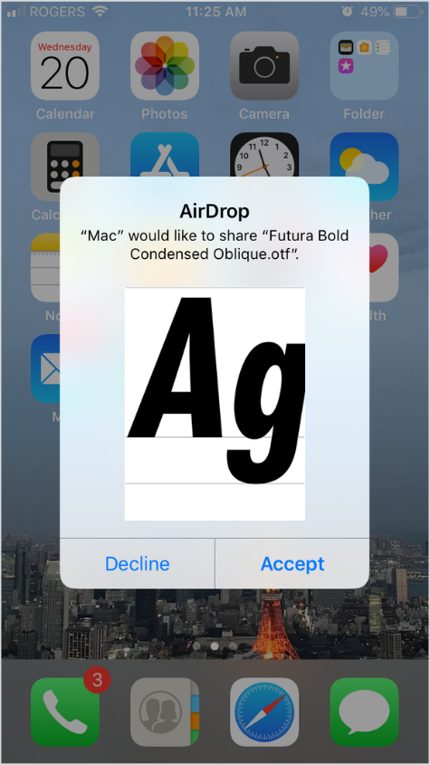 The Futura Bold Condensed Oblique font is airdropped to an iPhone
