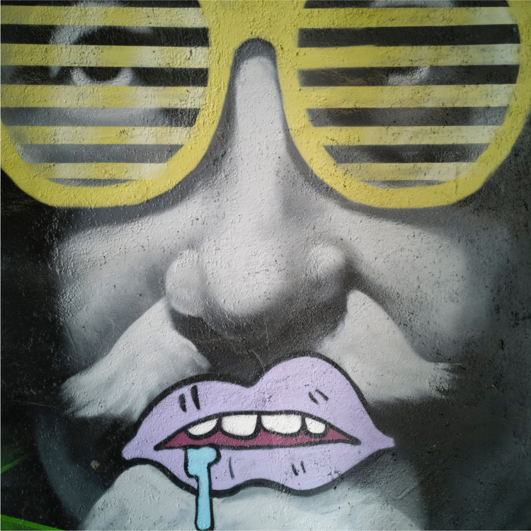 Grafitti of man with yellow fake sunglasses