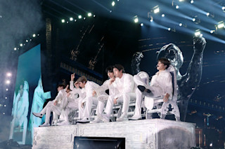 Screen showing band boys at concert