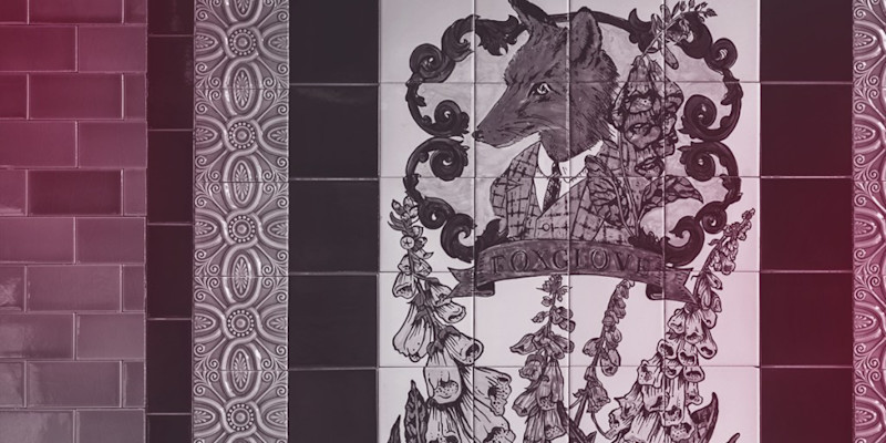 Foxglove painting and logo on tiled wall