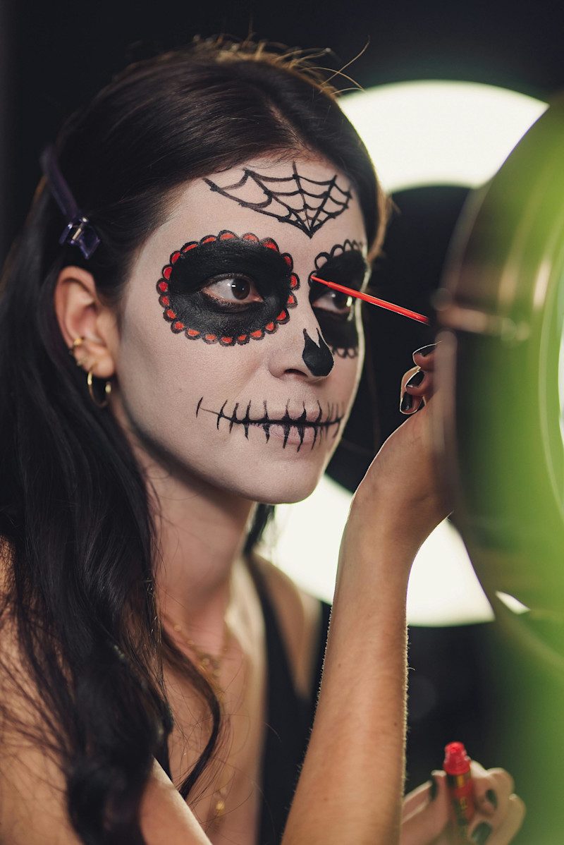 Woman Applying Halloween Makeup
