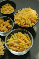 Raw pasta in bowls