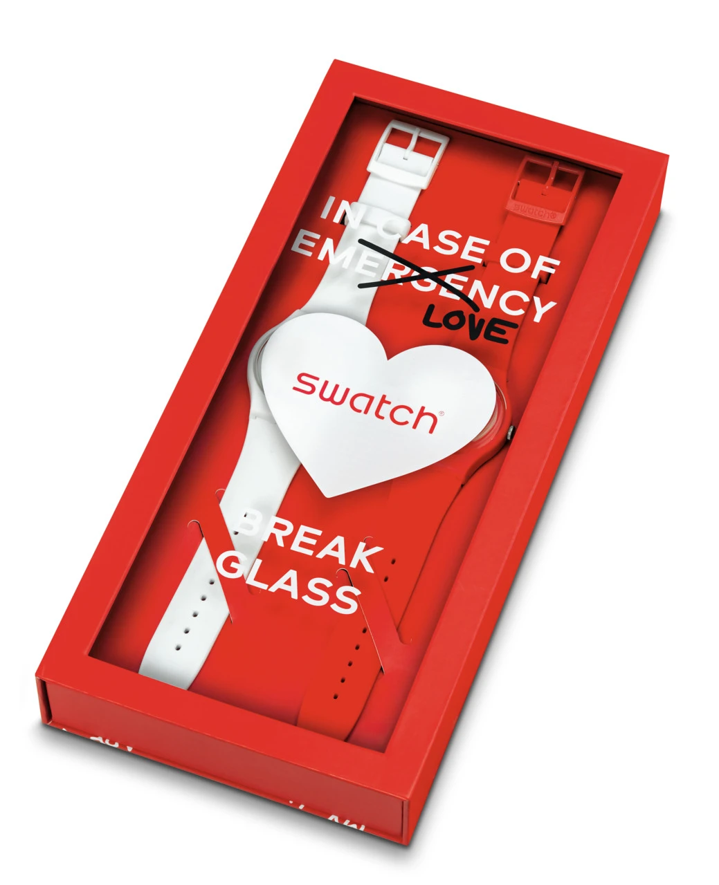 A swatch wristwatch shaped like a heart, placed inside a red box resembling an emergency break glass unit, with text reading "in case of emergency love.