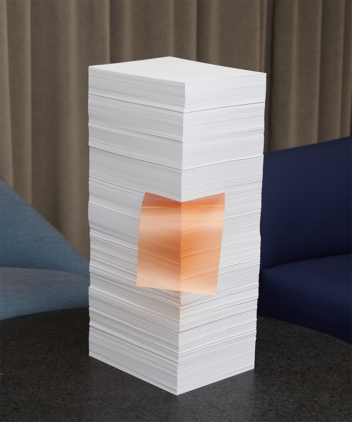 A stack of papers on a modern coffee table