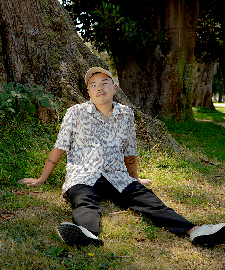 Kris Mendoza sitting on grass