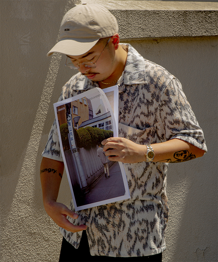 Kris holding magazine and looking down at it