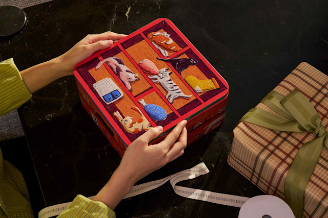 Photo of holiday tin lid being removed