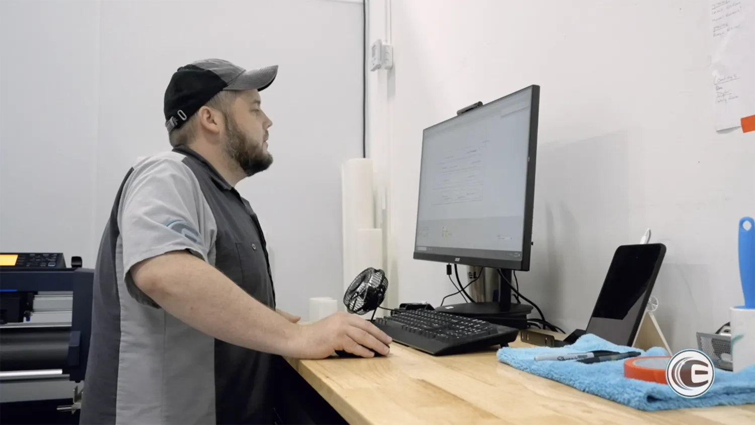 Professional installers applying Xpel paint protection film to cars.