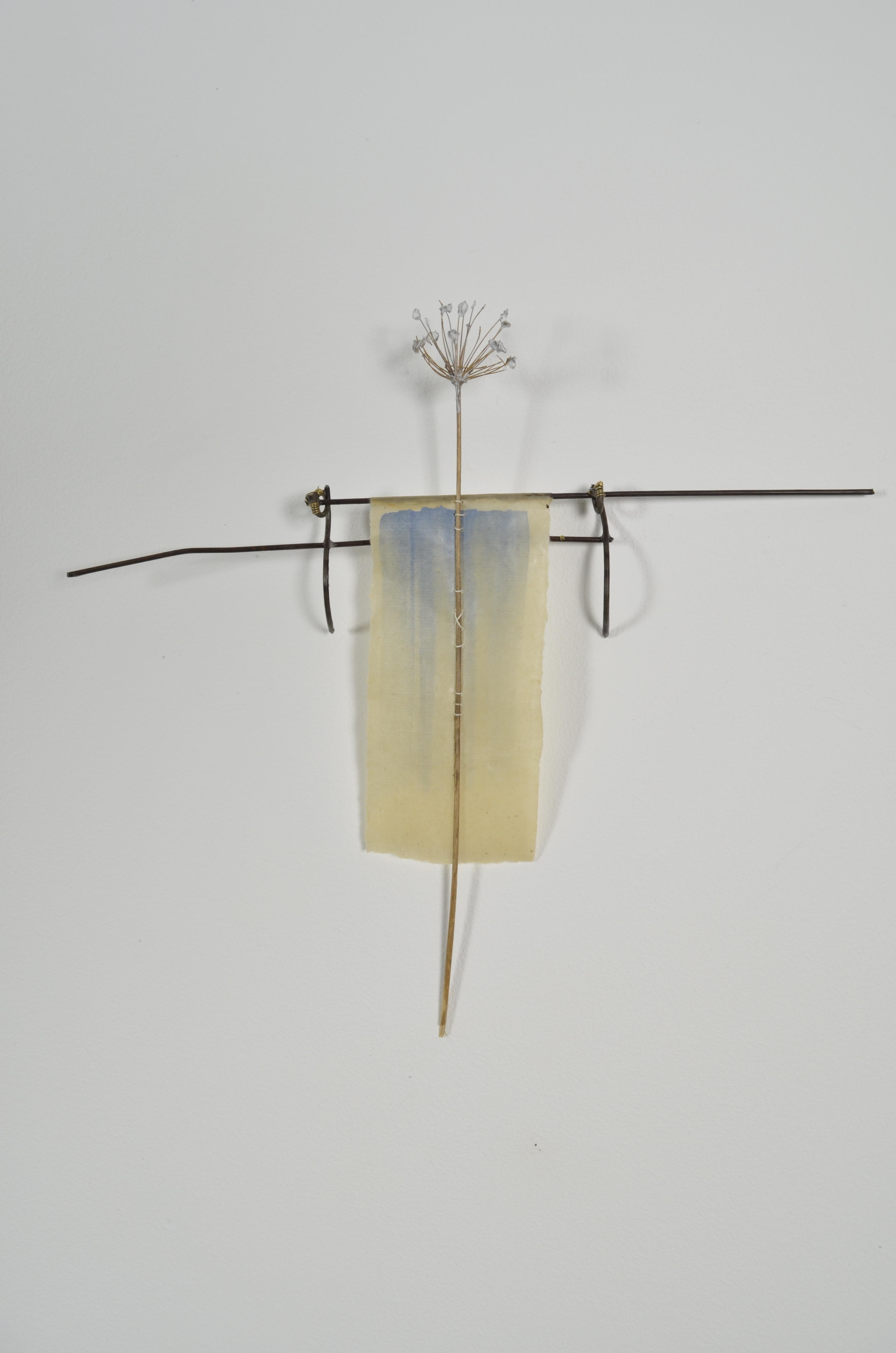 Unbleached mulberry paper with water color is sealed in encaustic, wrapped liked a paper doll dress over the found fence section of arms with an allium sealed in encaustic is sewn on top of the dress.