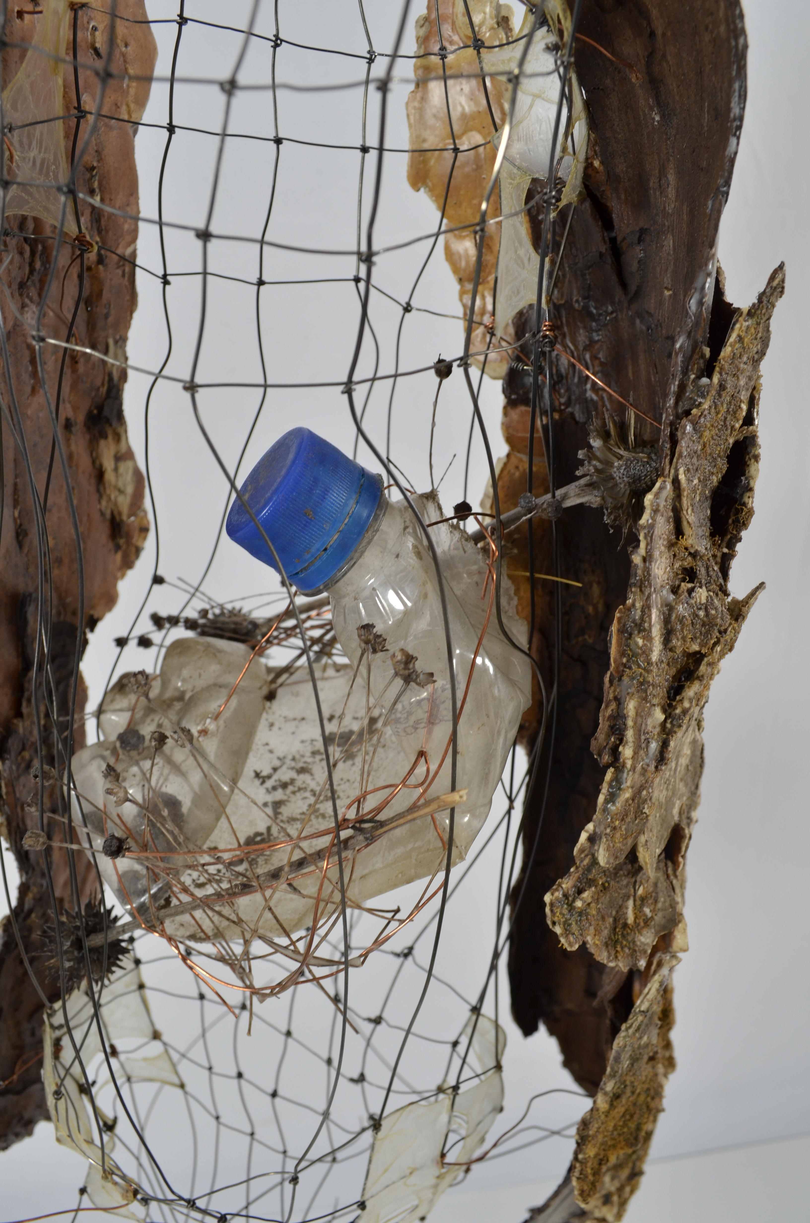 Found ephemera all sealed in encaustic, gut, found fence, wire, plastic bottles, have been sectioned together to create a tree.  