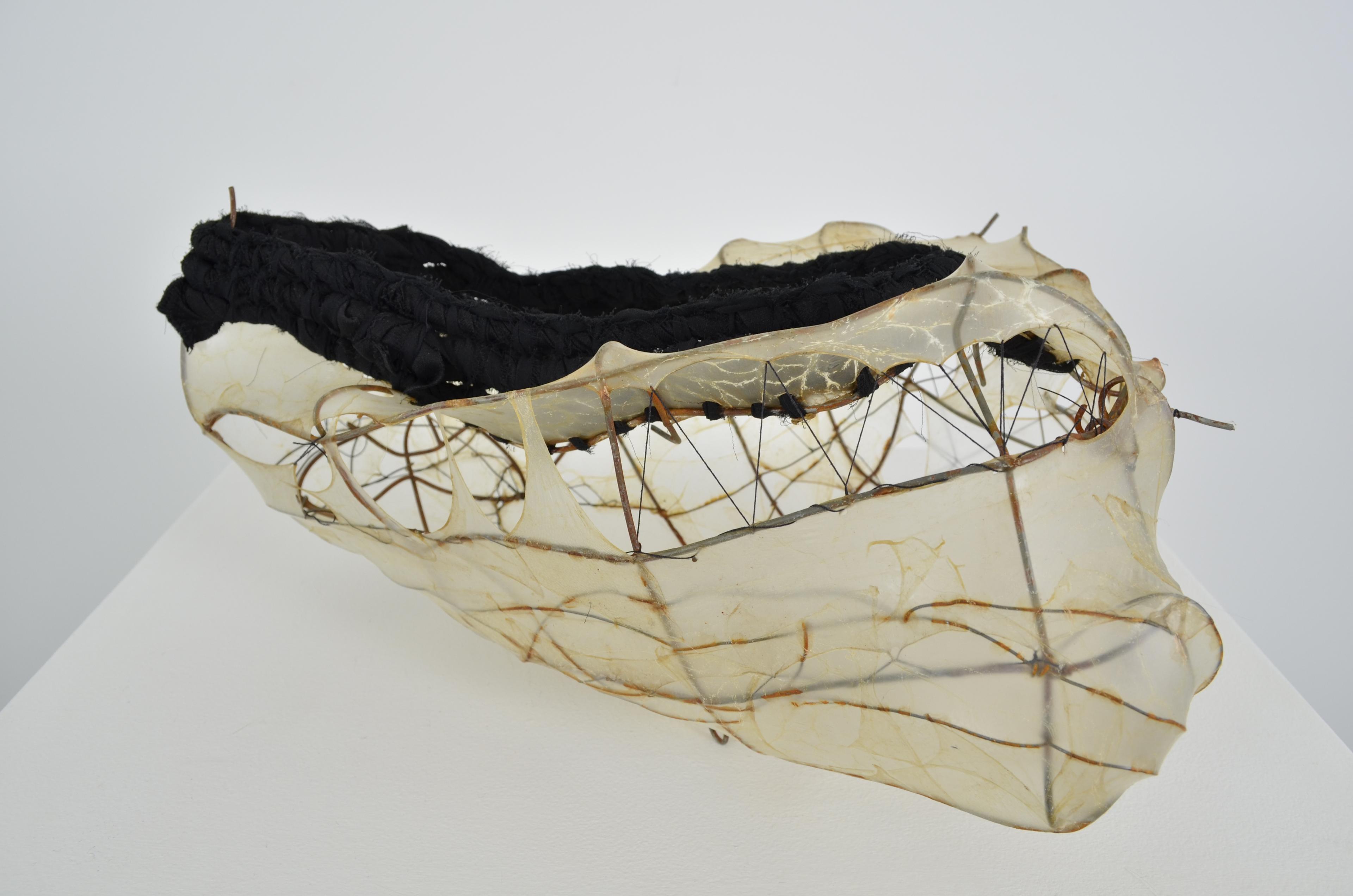 Found fence shaped into a vessel form, with upcycled skirt coiled on top of the stretched gut and sewn vessel shape with some extra steel wire. 7.5X14.5X12