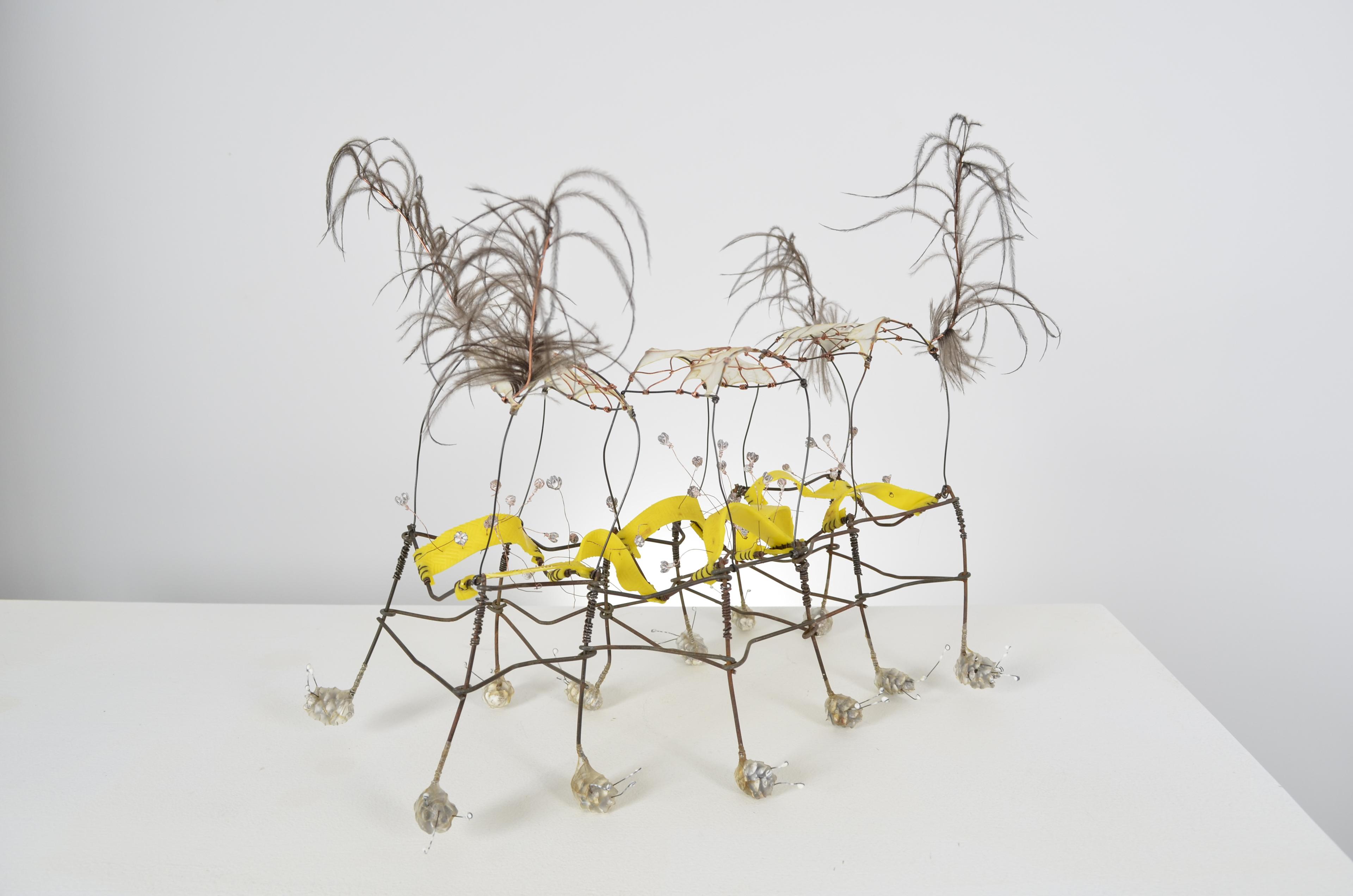 This caterpillar like critter is assembled from a found rubber ball, feathers, found fence, annealed steel wire, copper wire, gut, encaustic, hemlock cones and the legs articulate to move and shift.  11.5X18X11.5