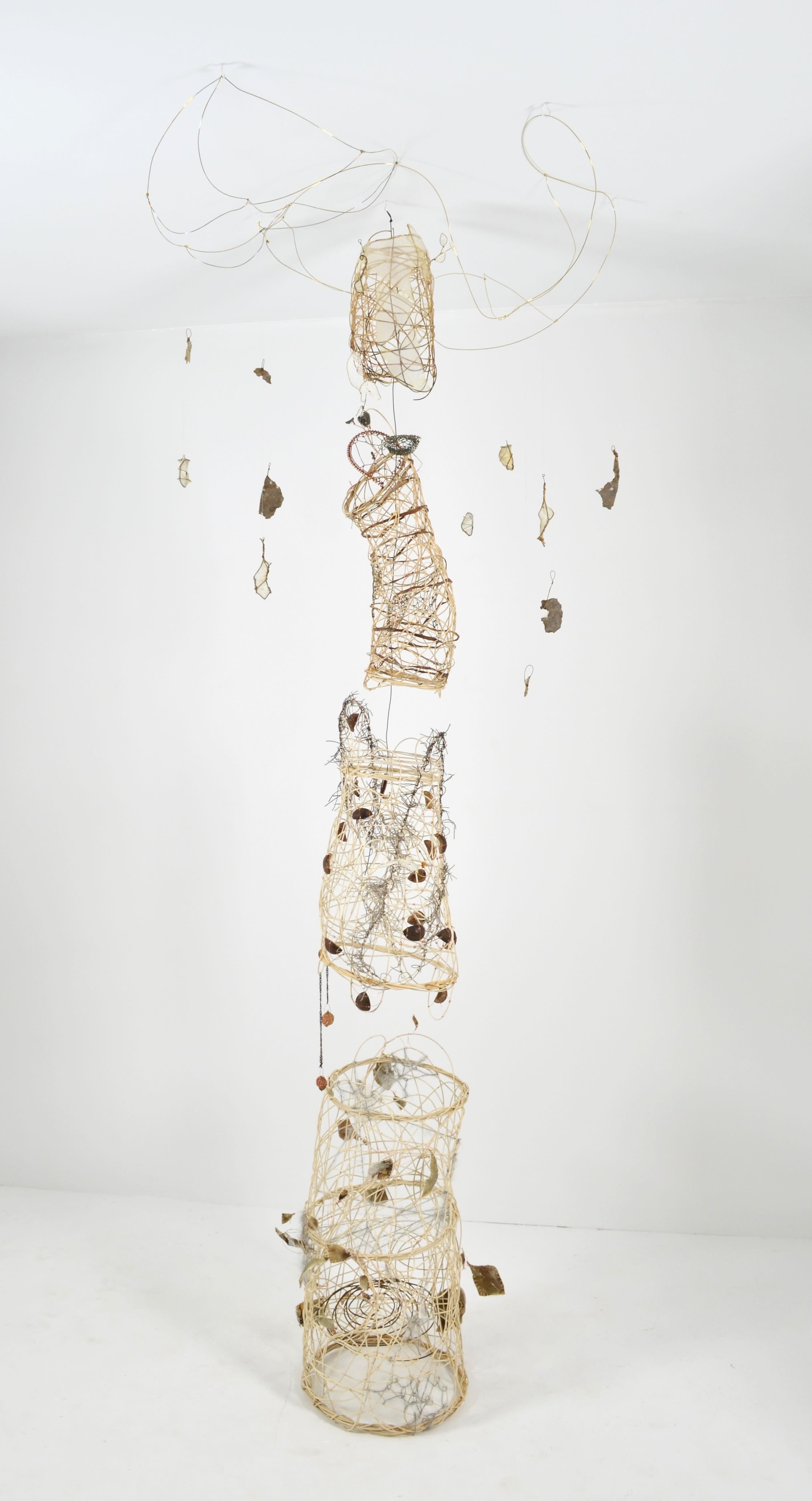 Randomly woven sections of reed have been created to complete a tree.  Each section has multiple textile techniques found items, wire, threads, and the foliage is found objects sealed in gut suspended from brass wire. 