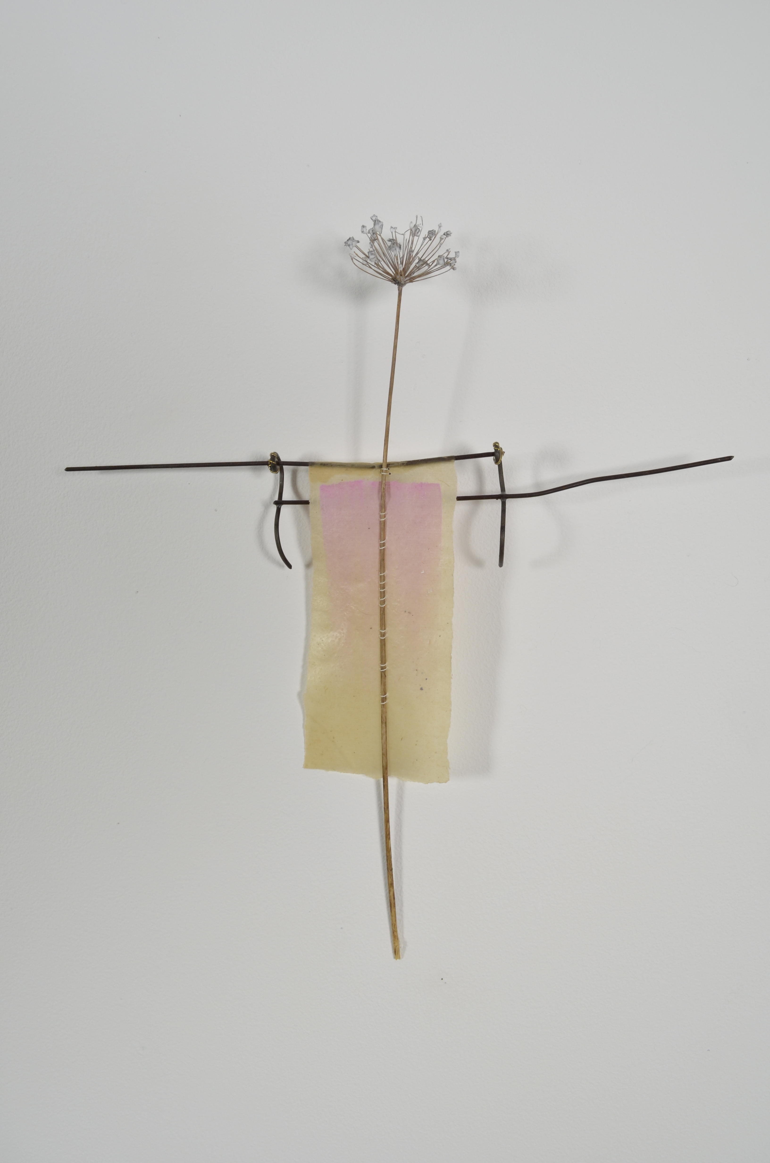 Unbleached mulberry paper with water color is sealed in encaustic, wrapped liked a paper doll dress over the found fence section of arms with an allium sealed in encaustic is sewn on top of the dress.
