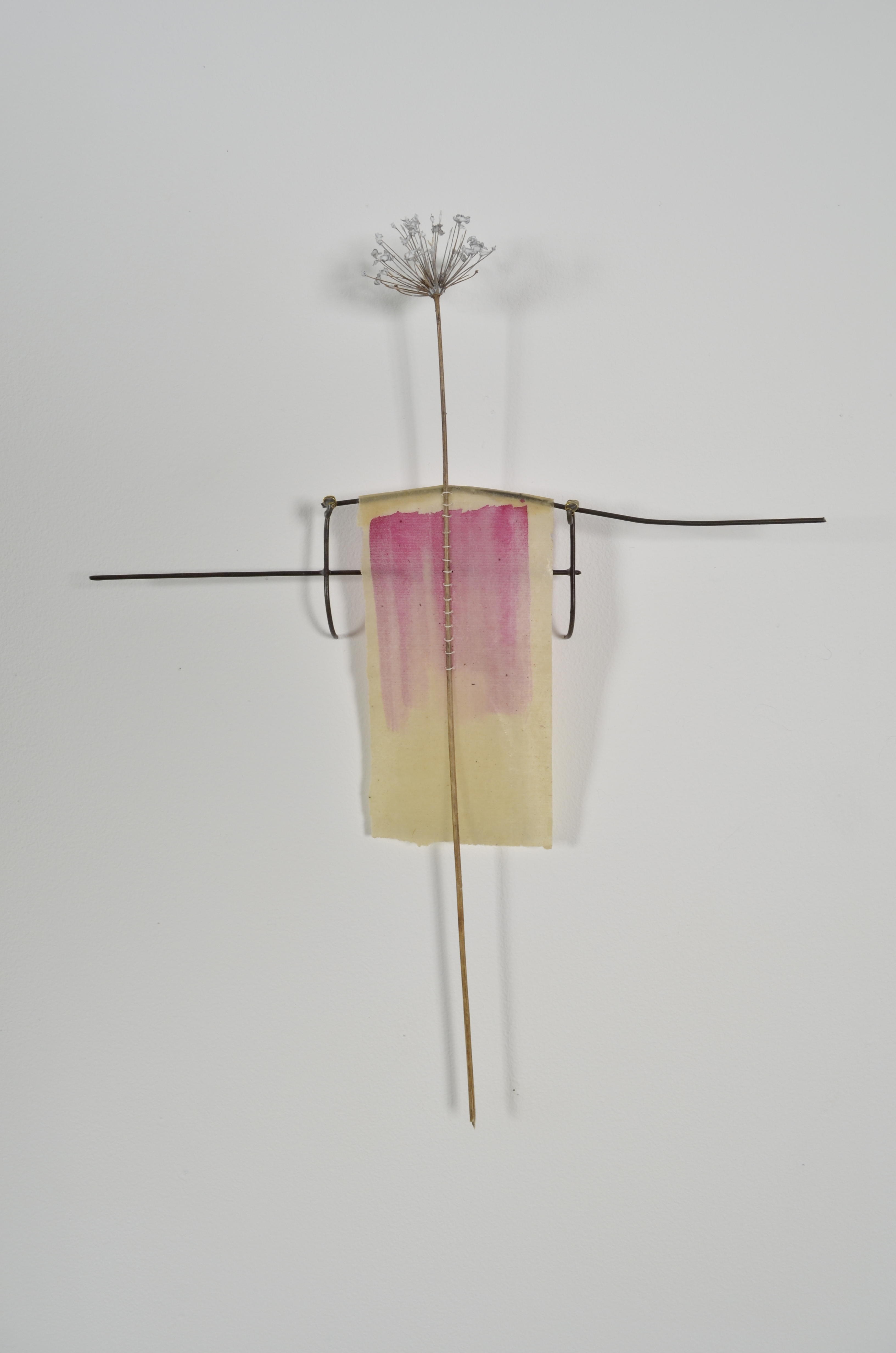 Unbleached mulberry paper with water color is sealed in encaustic, wrapped liked a paper doll dress over the found fence section of arms with an allium sealed in encaustic is sewn on top of the dress.