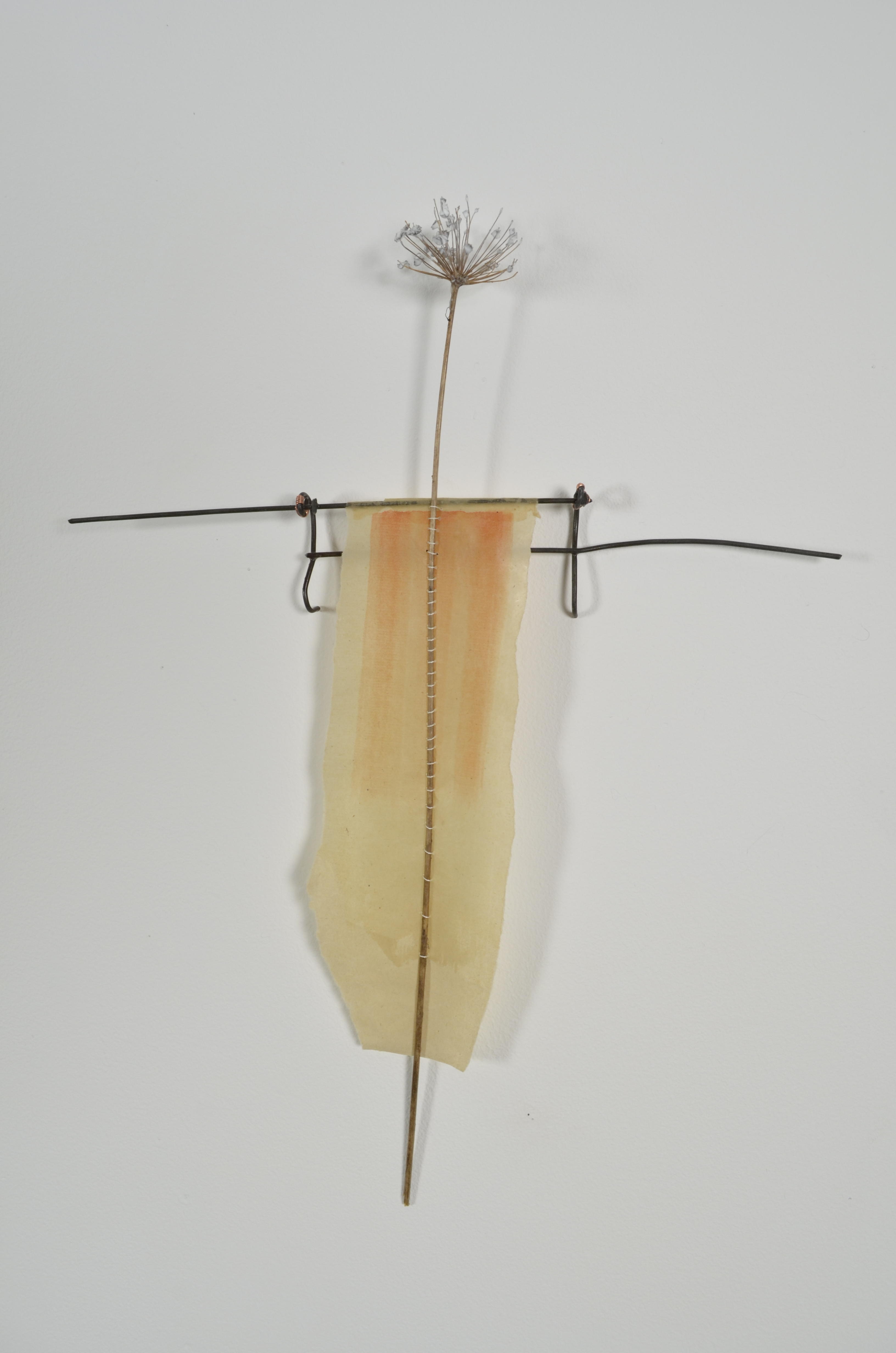 Unbleached mulberry paper with water color is sealed in encaustic, wrapped liked a paper doll dress over the found fence section of arms with an allium sealed in encaustic is sewn on top of the dress.