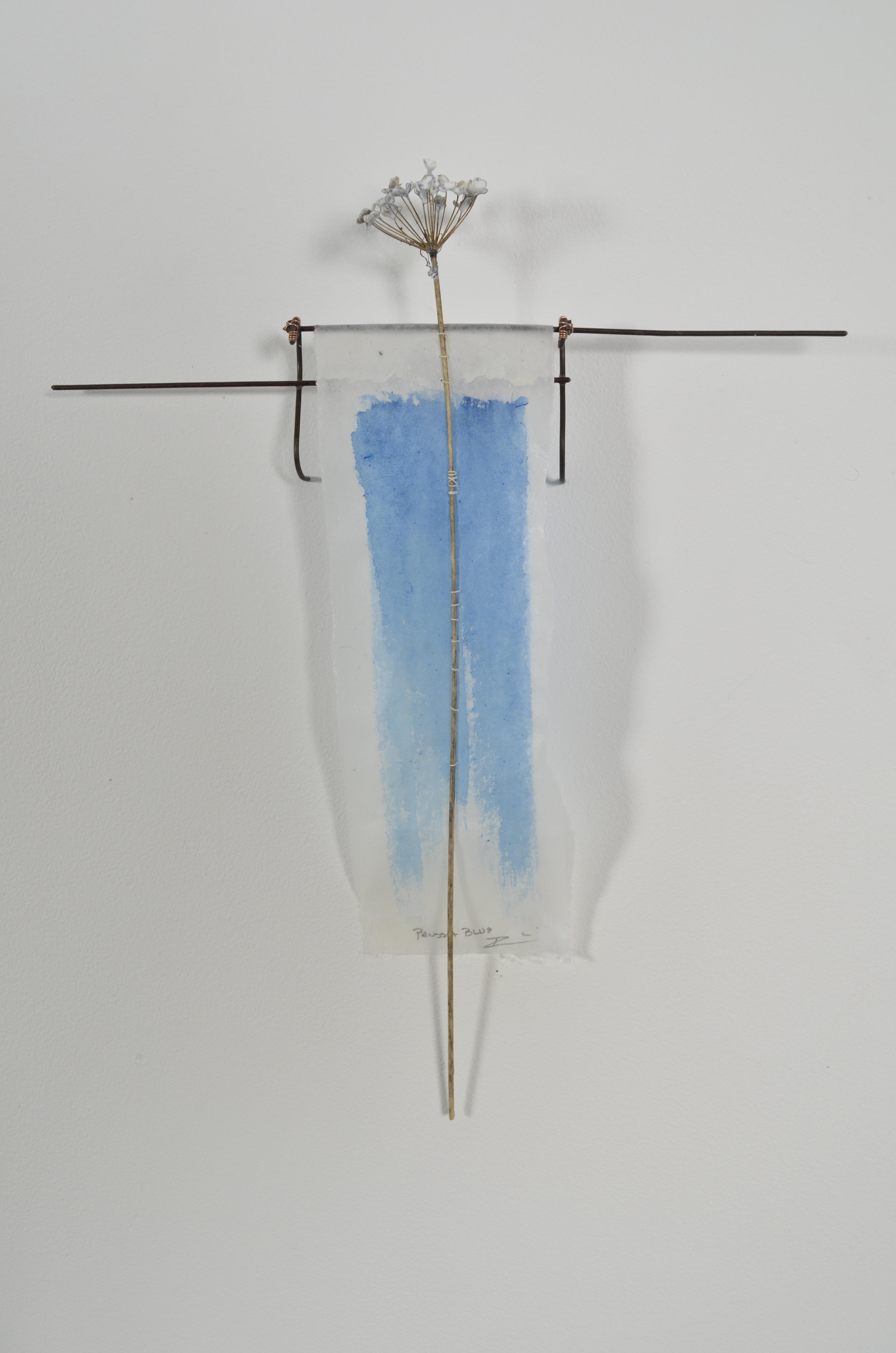 Bleached mulberry paper with water color is sealed in encaustic, wrapped liked a paper doll dress over the found fence section of arms with an allium sealed in encaustic is sewn on top of the dress.