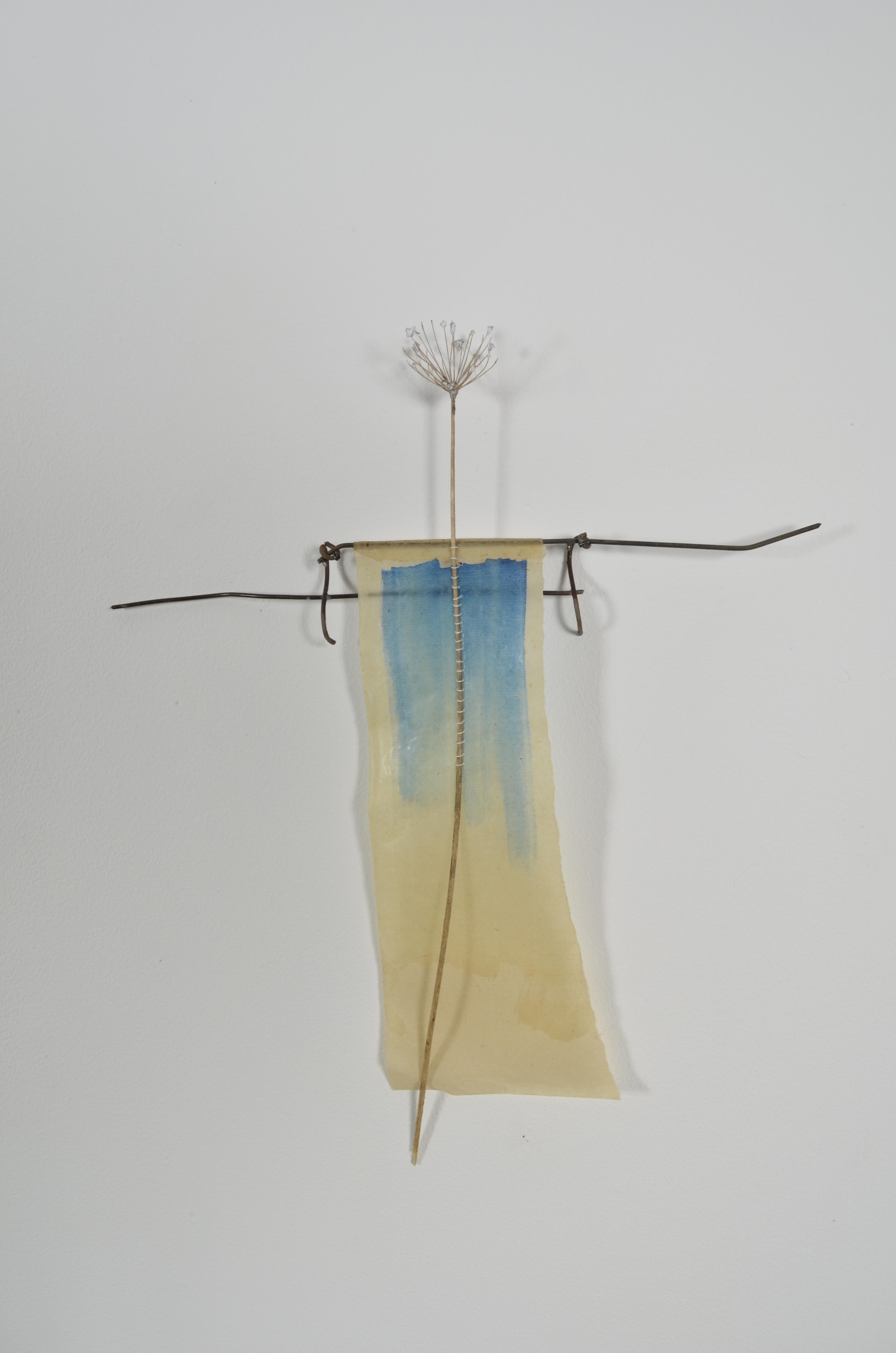 Unbleached mulberry paper with water color is sealed in encaustic, wrapped liked a paper doll dress over the found fence section of arms with an allium sealed in encaustic is sewn on top of the dress.