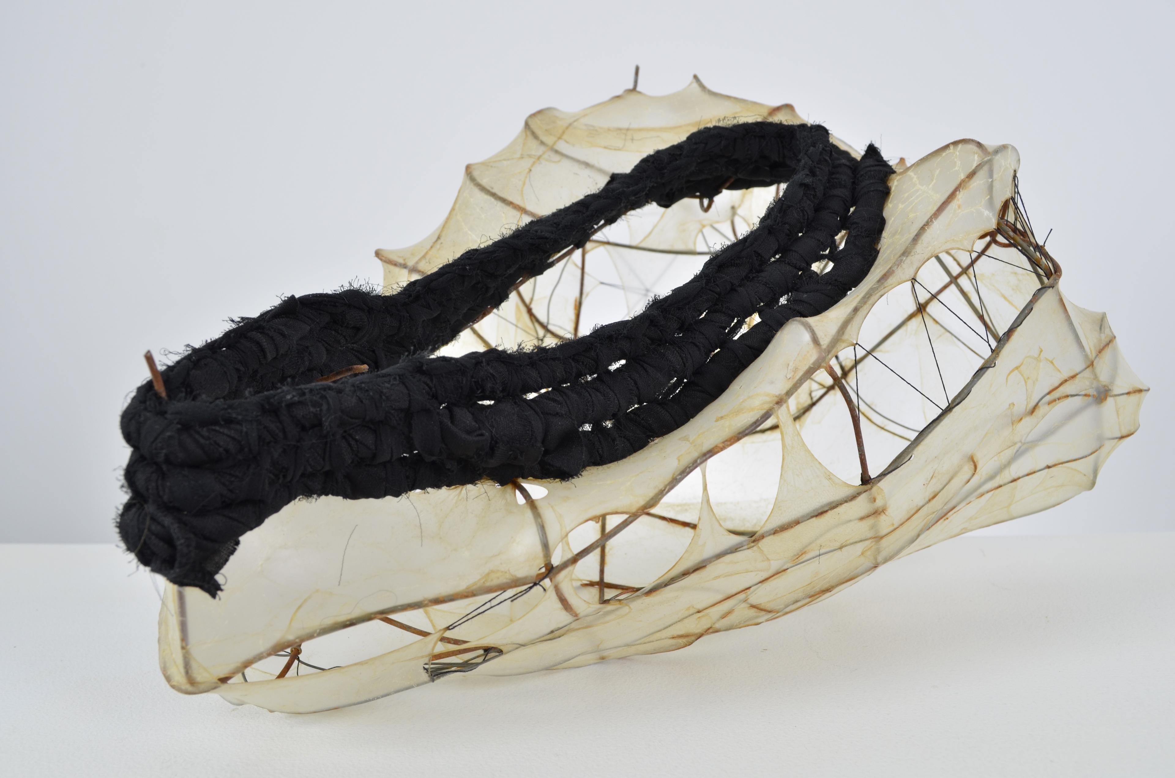 Found fence shaped into a vessel form, with upcycled skirt coiled on top of the stretched gut and sewn vessel shape with some extra steel wire. 7.5X14.5X12