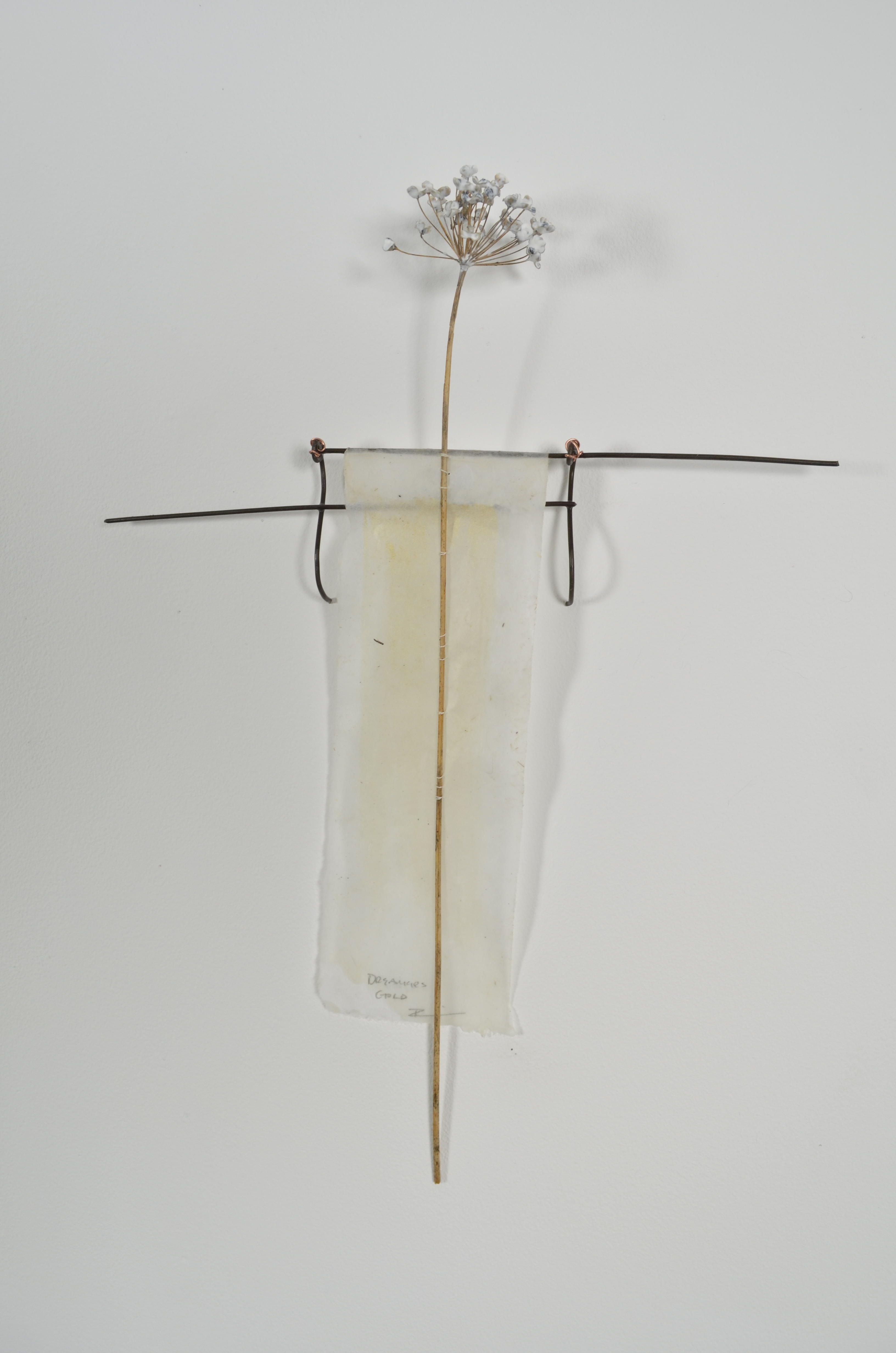 Bleached mulberry paper with water color is sealed in encaustic, wrapped liked a paper doll dress over the found fence section of arms with an allium sealed in encaustic is sewn on top of the dress.
