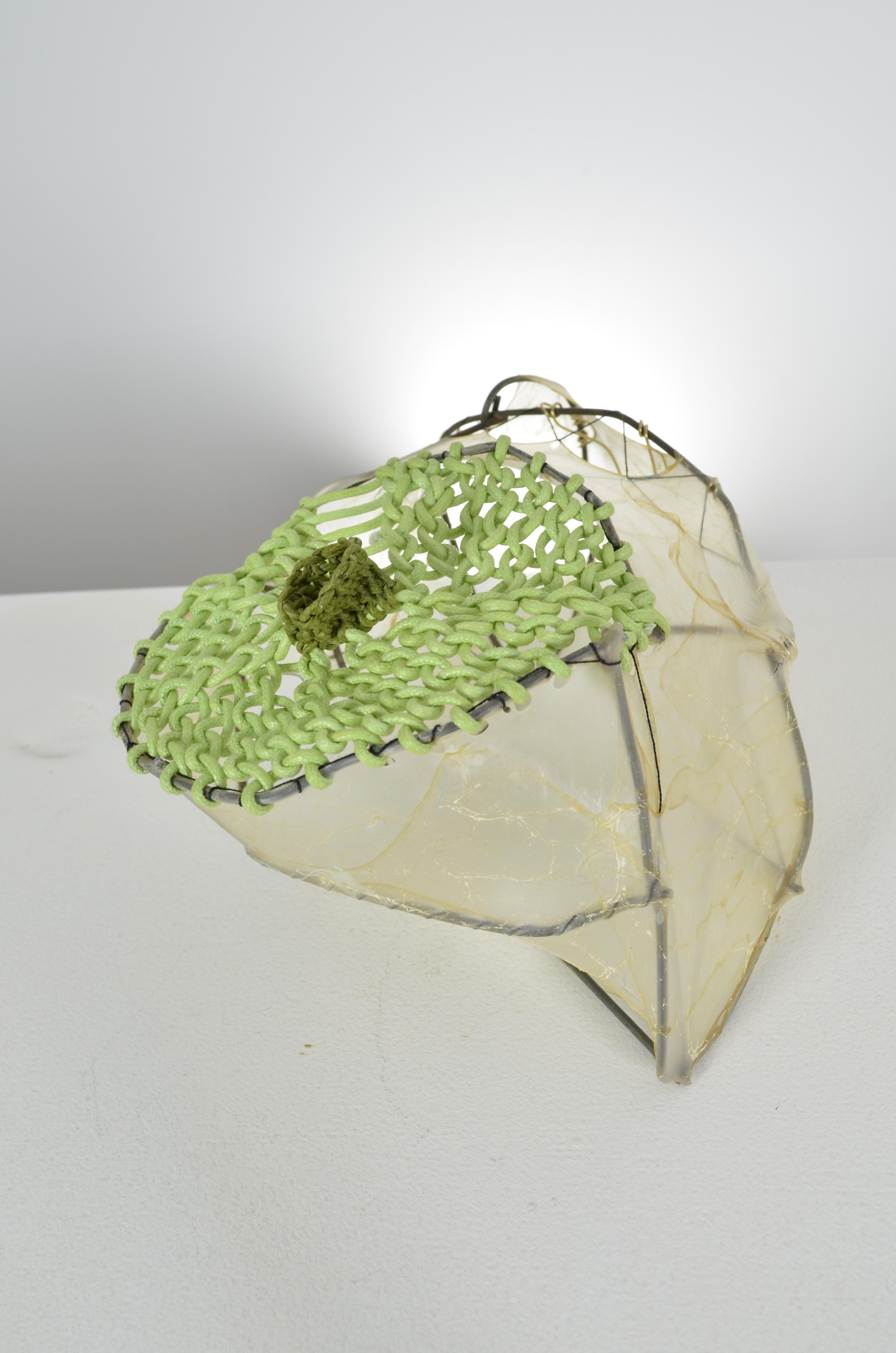 Green looped paper and waxed thread seal the top of the found fence form with stretched gut and thread.