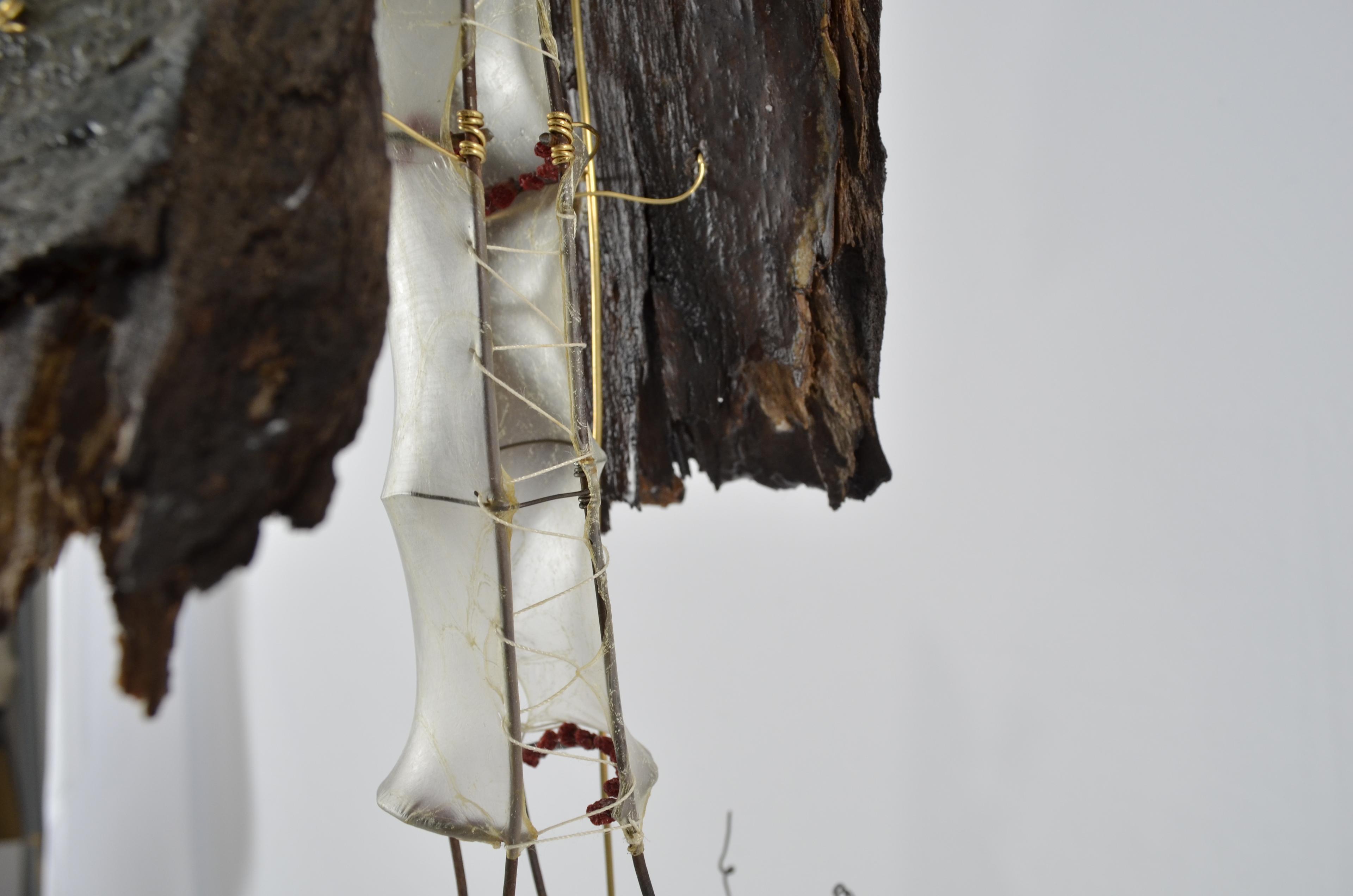 Found ephemera all sealed in encaustic, gut, found fence, wire, plastic bottles, have been sectioned together to create a tree.  