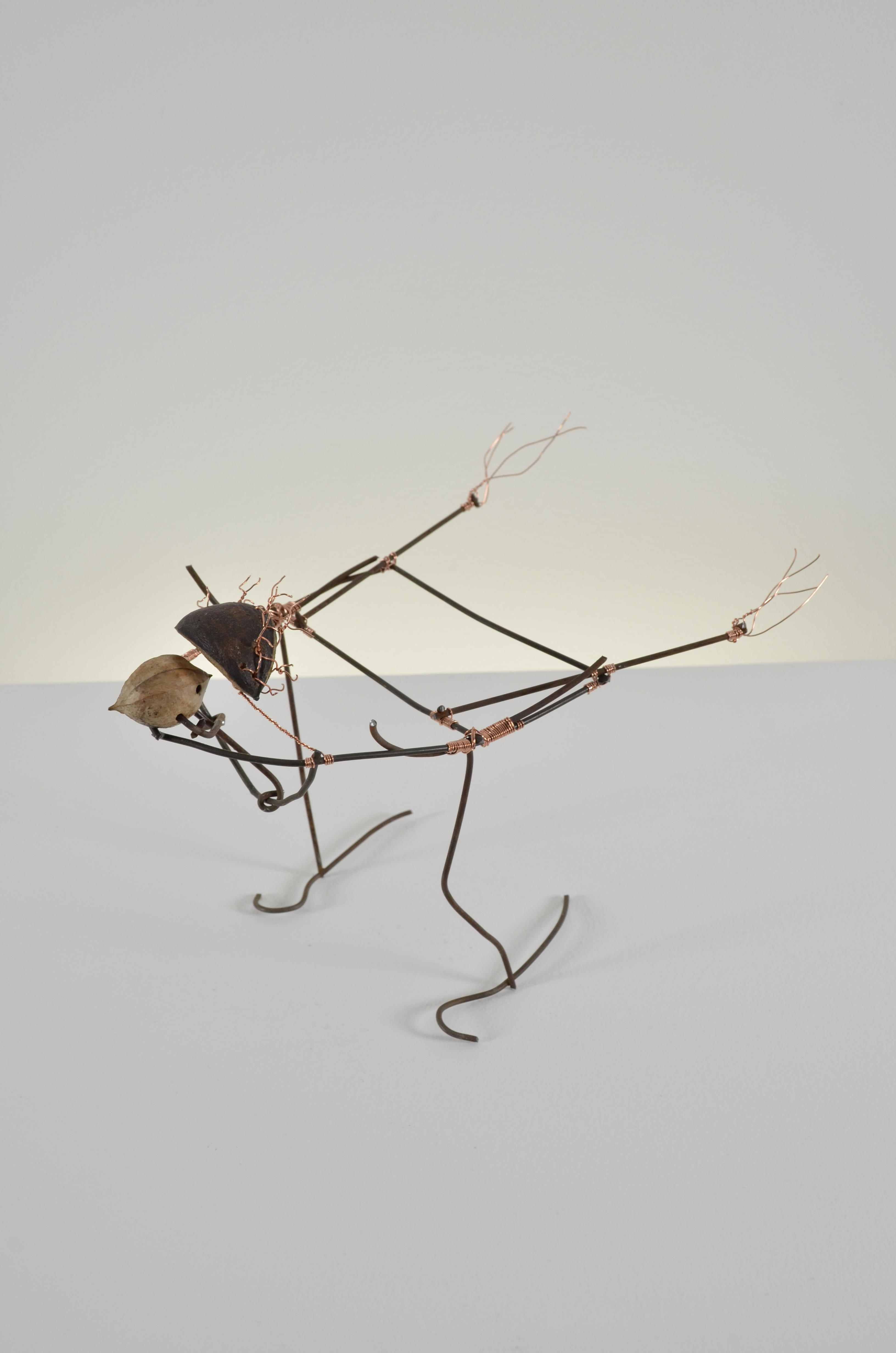 Gerty is an abstract bird made from found fence, copper wire, & walnuts.  SOLD