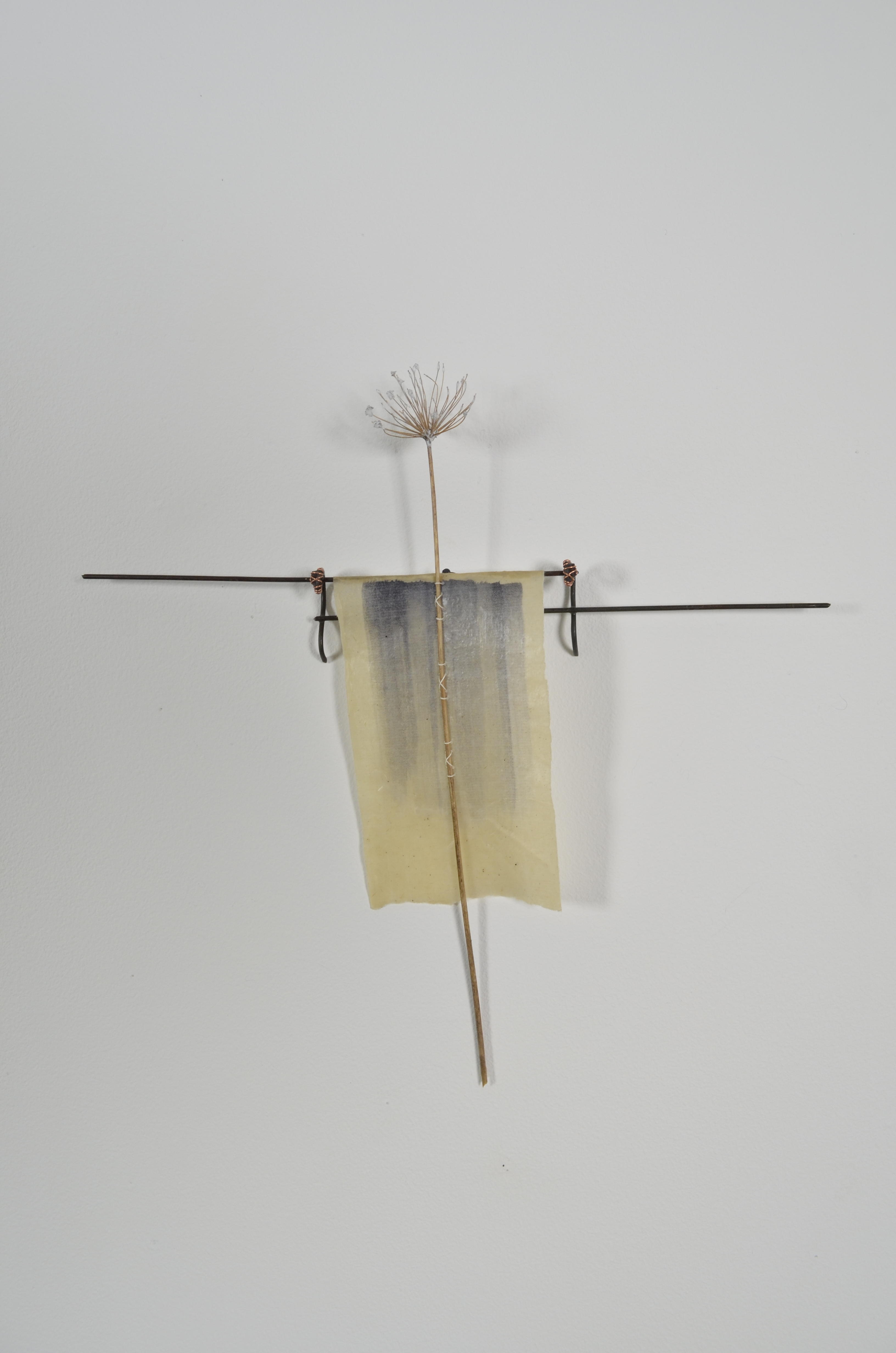 Unbleached mulberry paper with water color is sealed in encaustic, wrapped liked a paper doll dress over the found fence section of arms with an allium sealed in encaustic is sewn on top of the dress.