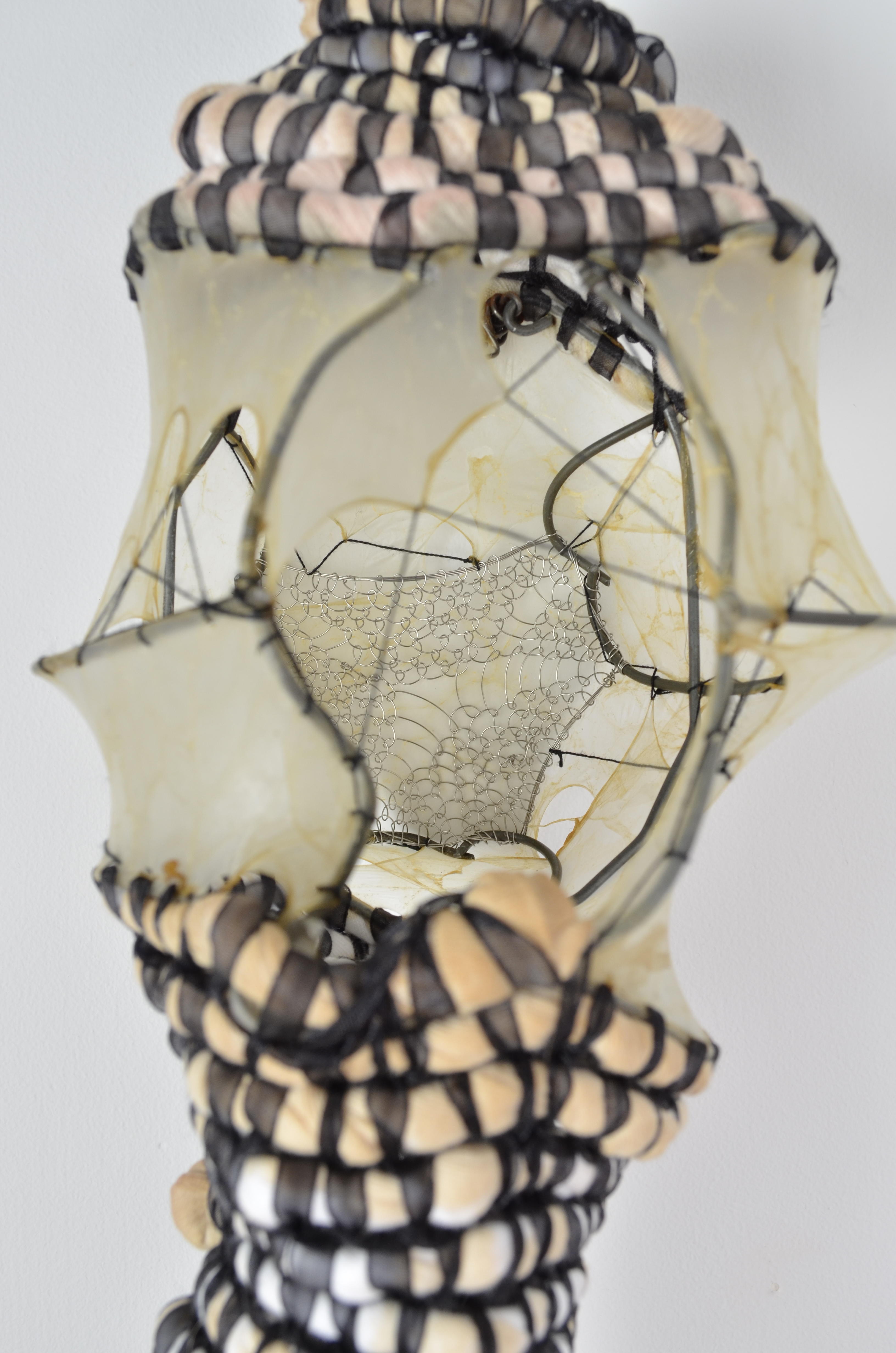Found fence, looped steel wire, thread, chiffon ribbon, gut, & tea stained upcycled undershirts have been shaped, stretched, & coiled into this form.  22x6x5