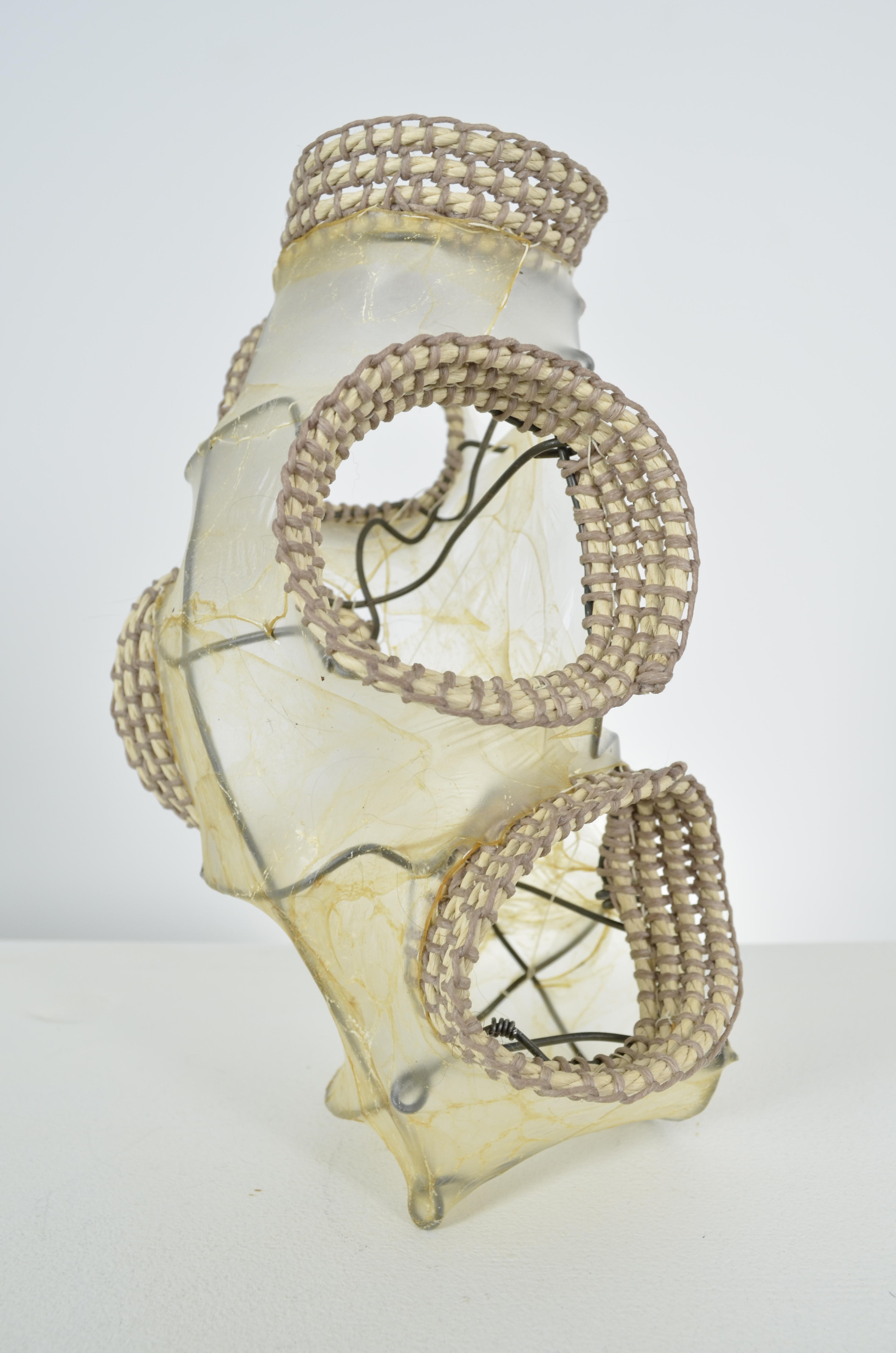 Found fence shaped into vertical vessel with sewn and stretched gut and multiple openings coiled with paper twine and waxed thread. 9X5.5X5.5