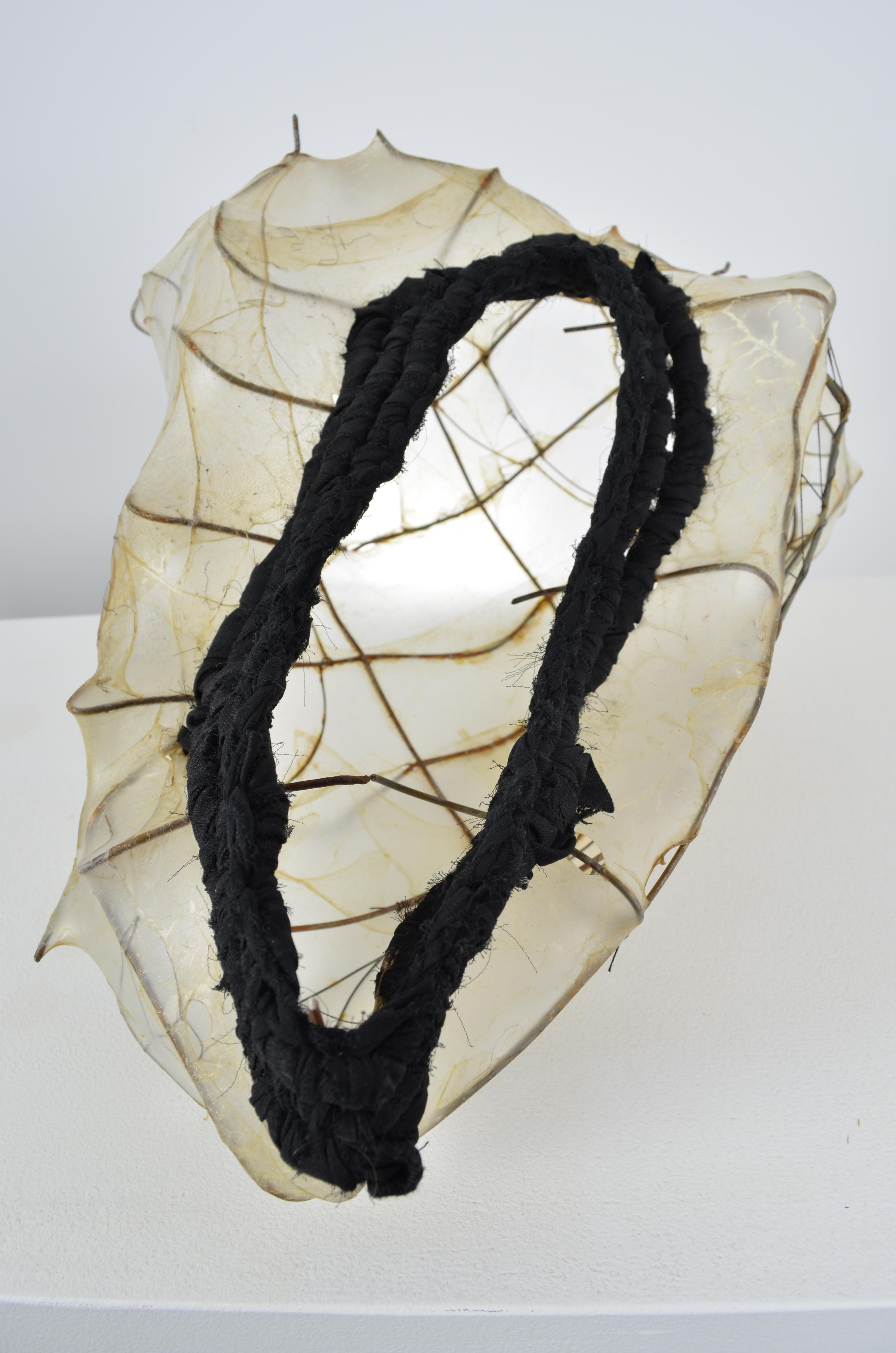 Found fence shaped into a vessel form, with upcycled skirt coiled on top of the stretched gut and sewn vessel shape with some extra steel wire. 7.5X14.5X12
