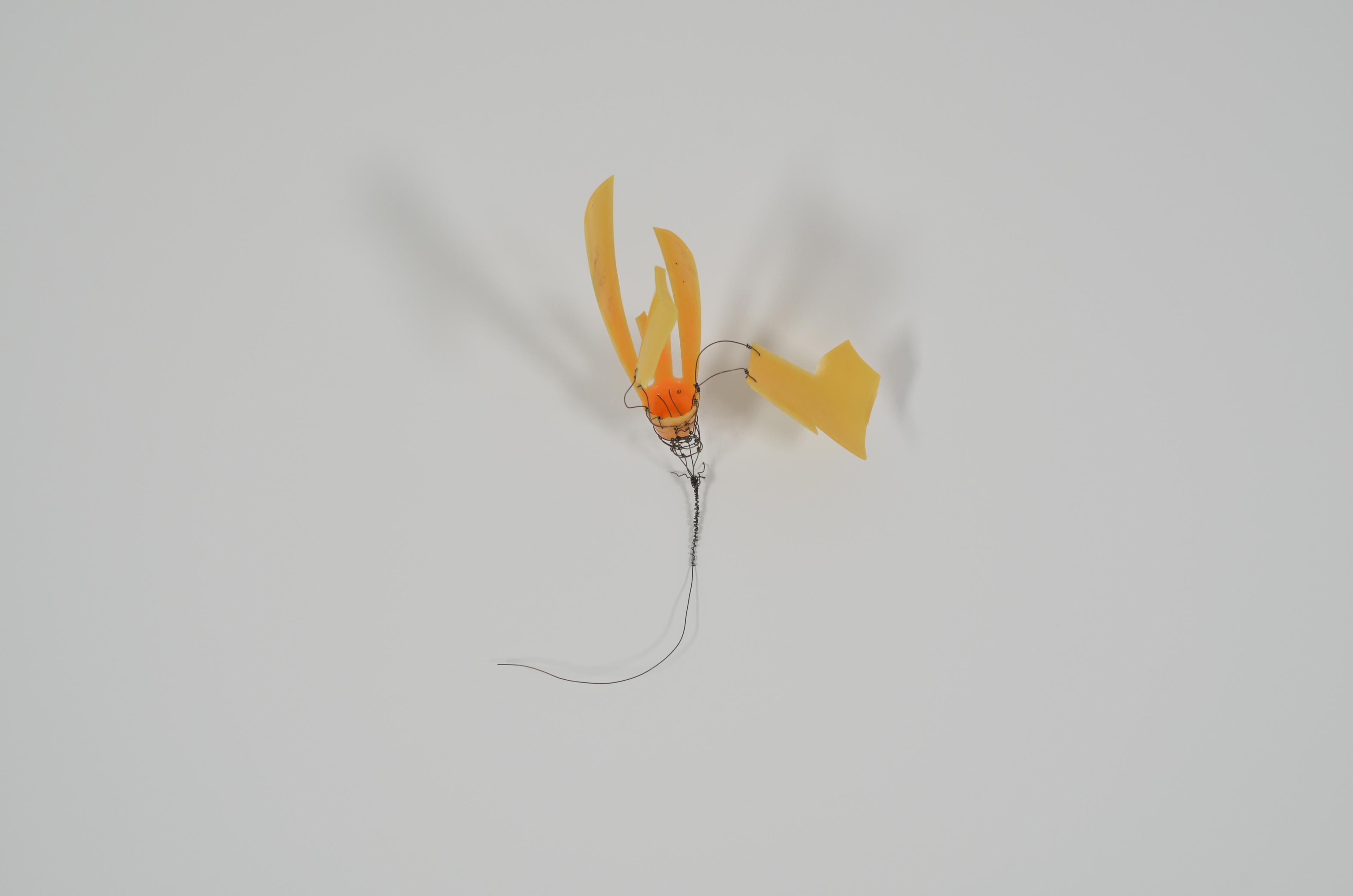 Found plastic toy upcycled with annealed steel wire.  The base of the flower is hand knotted and wrapped around the base of the orange.