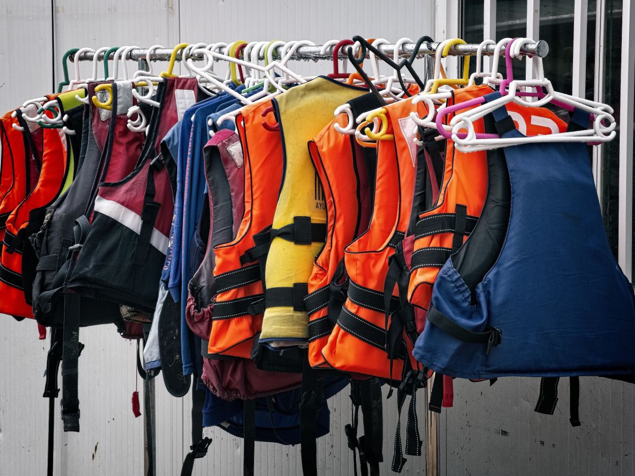 Life jackets hanging on rack