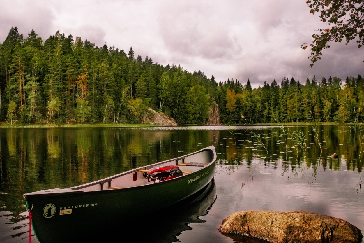 Canoe docked on shore of lake