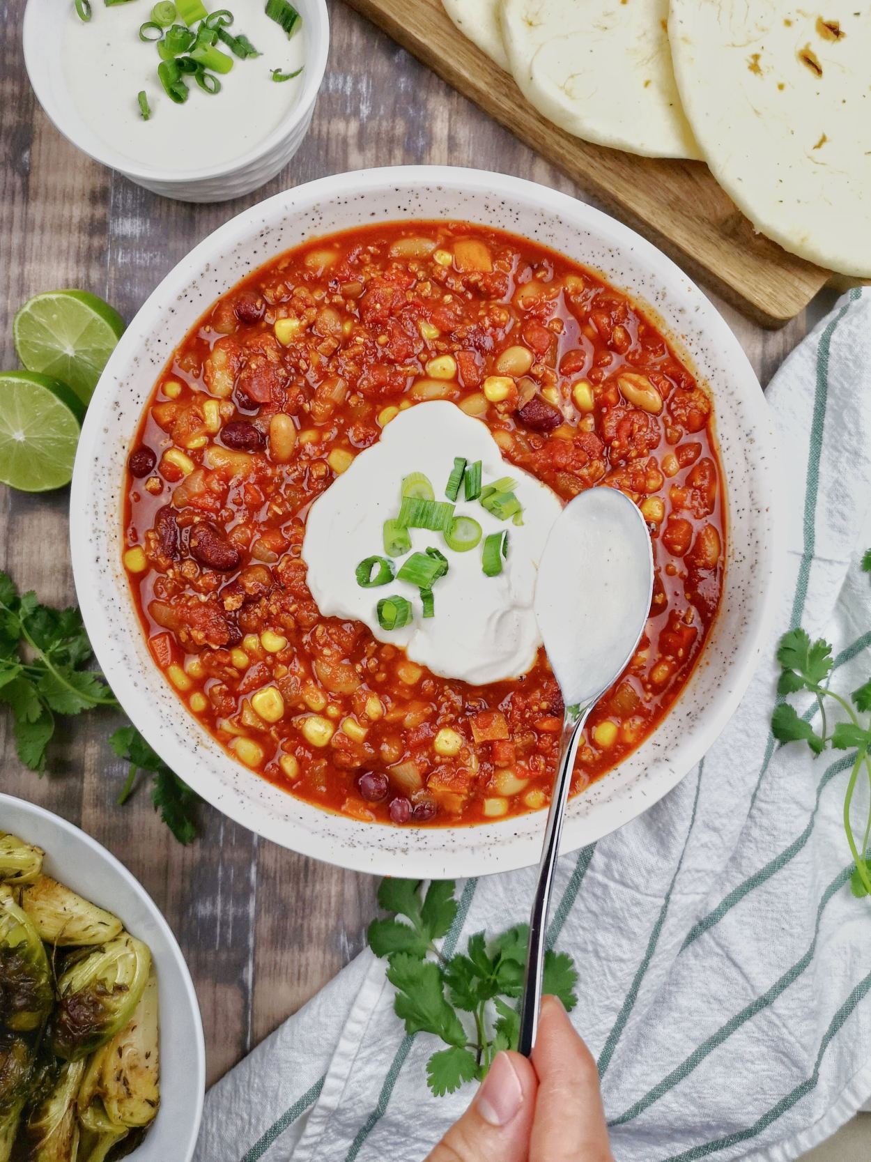 Vegan chili in bowl with dollop of sour cream