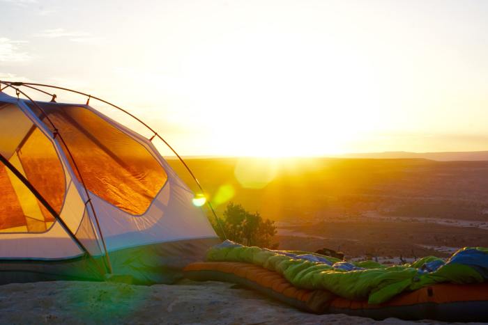 Sleeping bag laid out beside tent