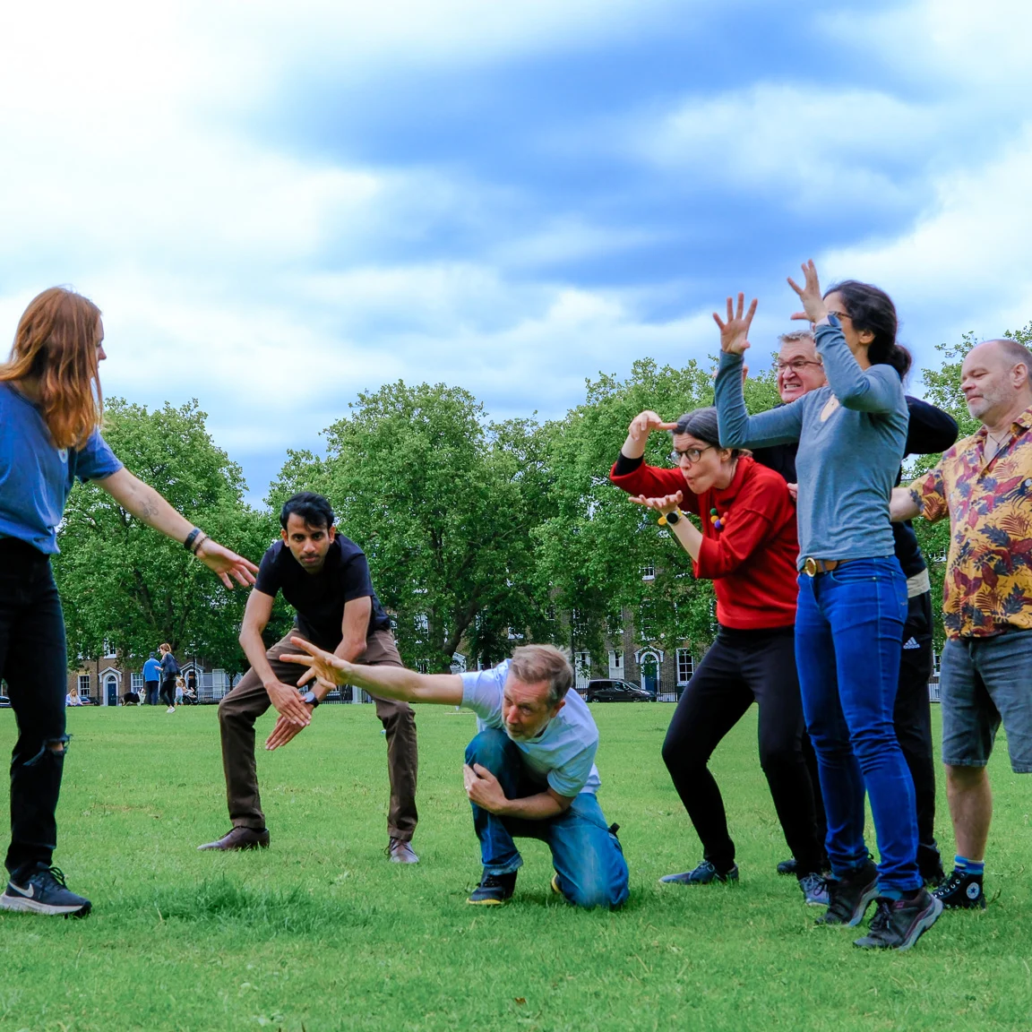 Play in the park Play workshop showing a group of adults creating a shape with their bodies