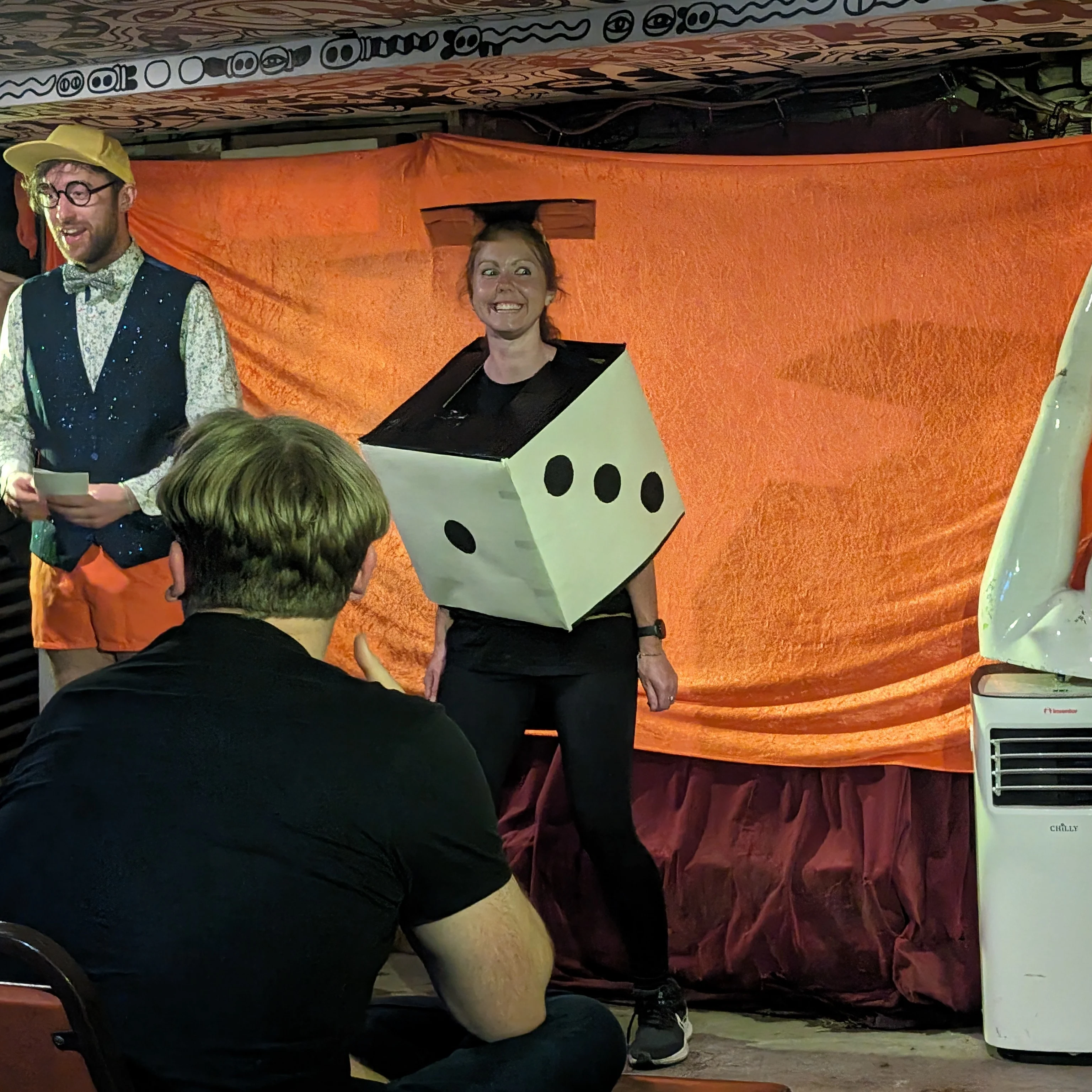 Modern Art Board Games MCs on stage as dice Modern Art Board Games Dice and mc on stage