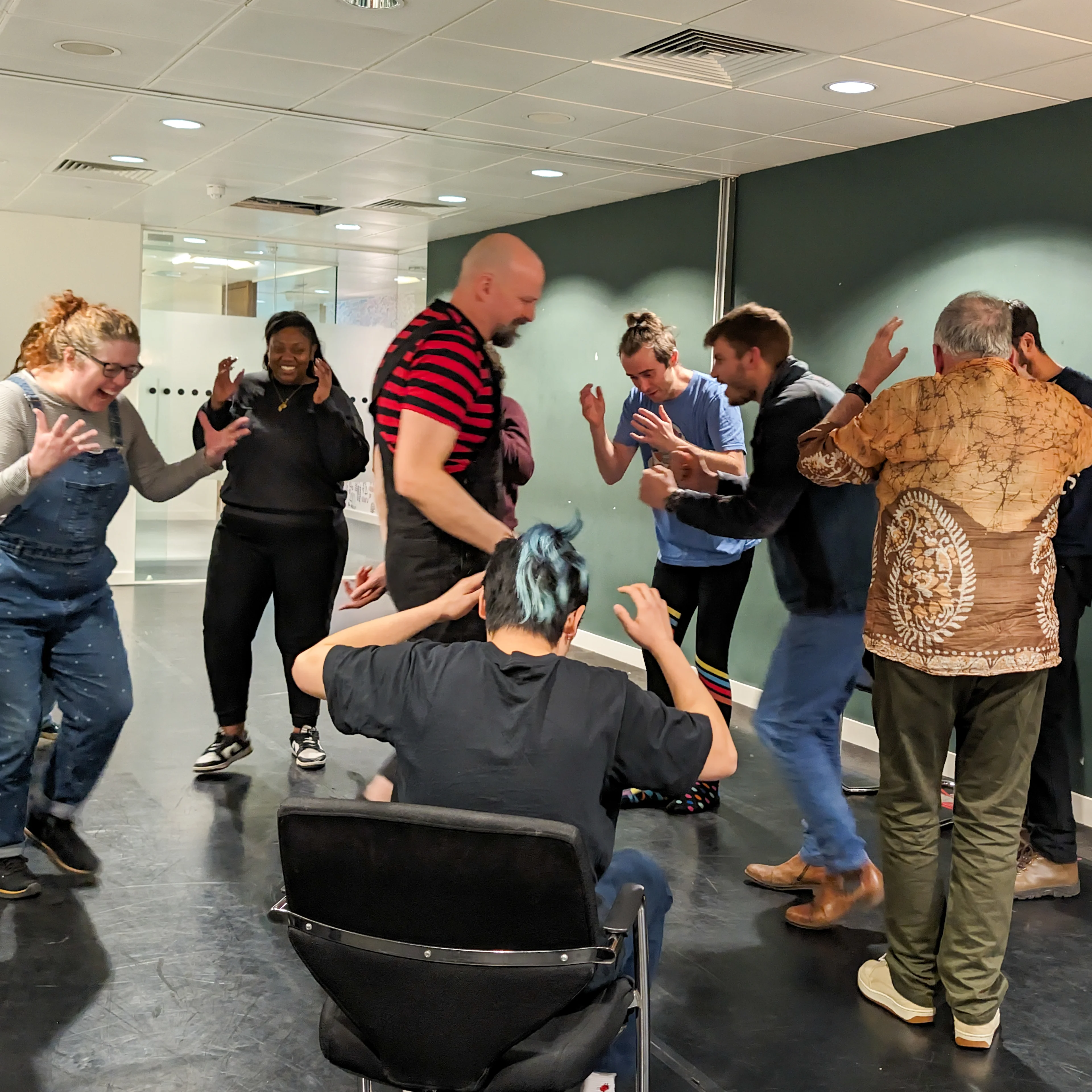 Clowning workshop circling game  Clowning workshop with participants walking in a circle wit their arms in the air