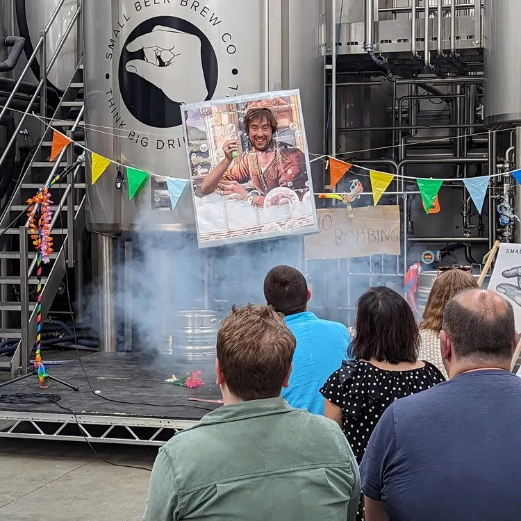 modern art variety July Charlie Comedian on stage wearing a portrait