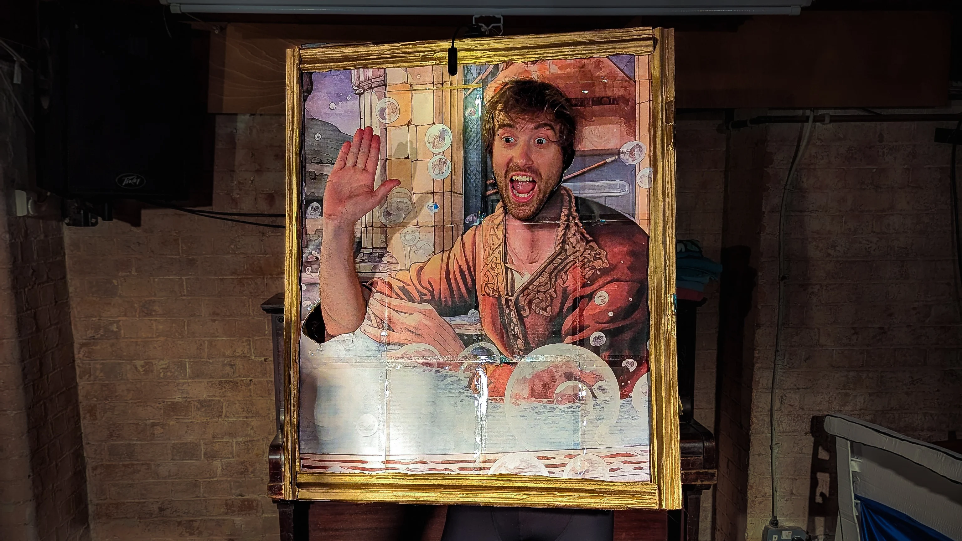 Charlie Jackson is wearing a portrait picture frame as a costume. The portrait is of a man taking a bath at some point in history. Charlie's head and right arm are visible via cut out sections of the portrait.