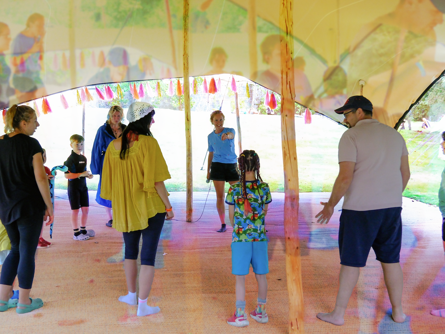 Families stood around in a workshop inside a tipi