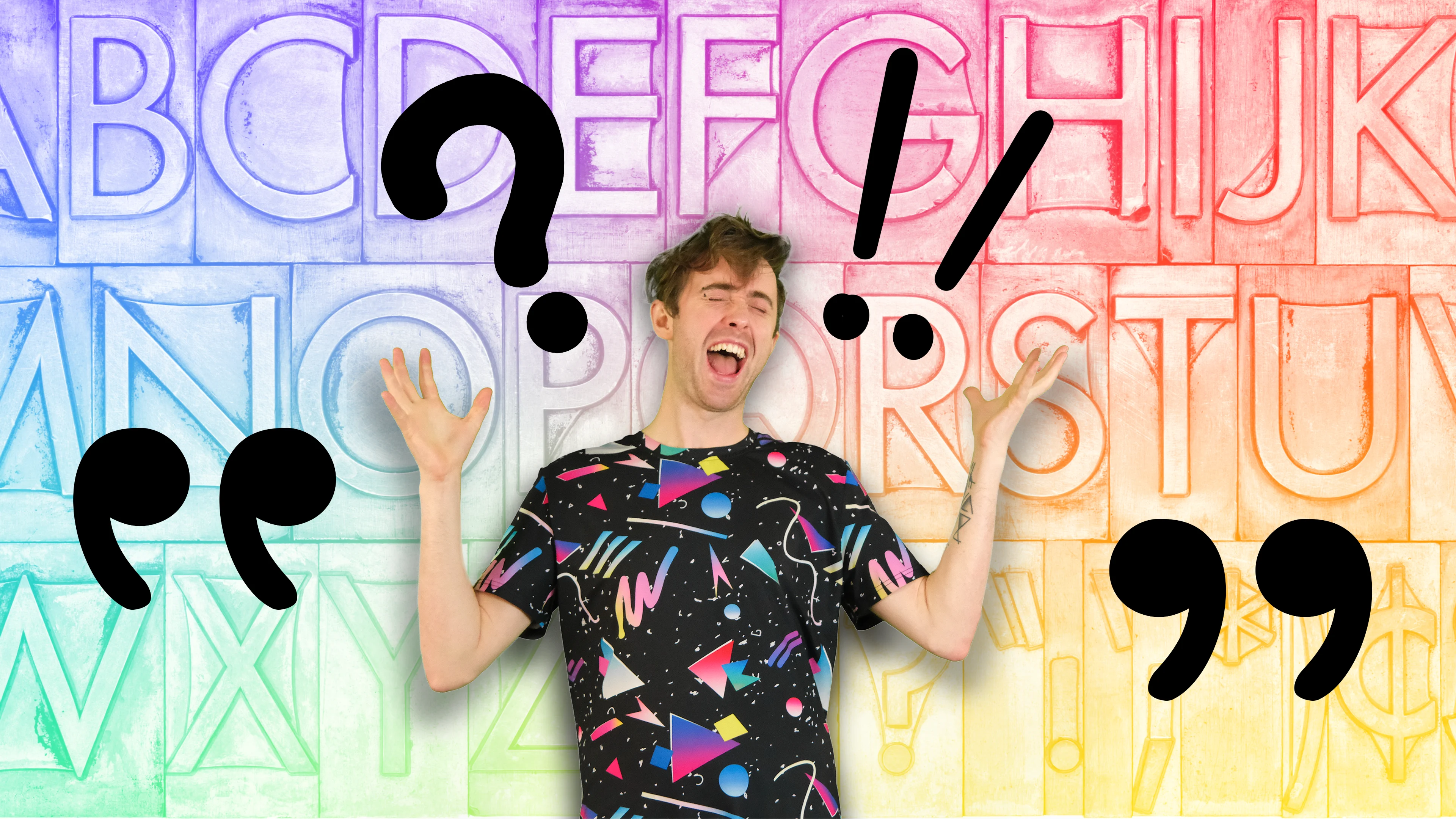 Charlie Jackson screaming to nothing with various punctuation marks floating around him. The background is the alphabet in rainbow colours.