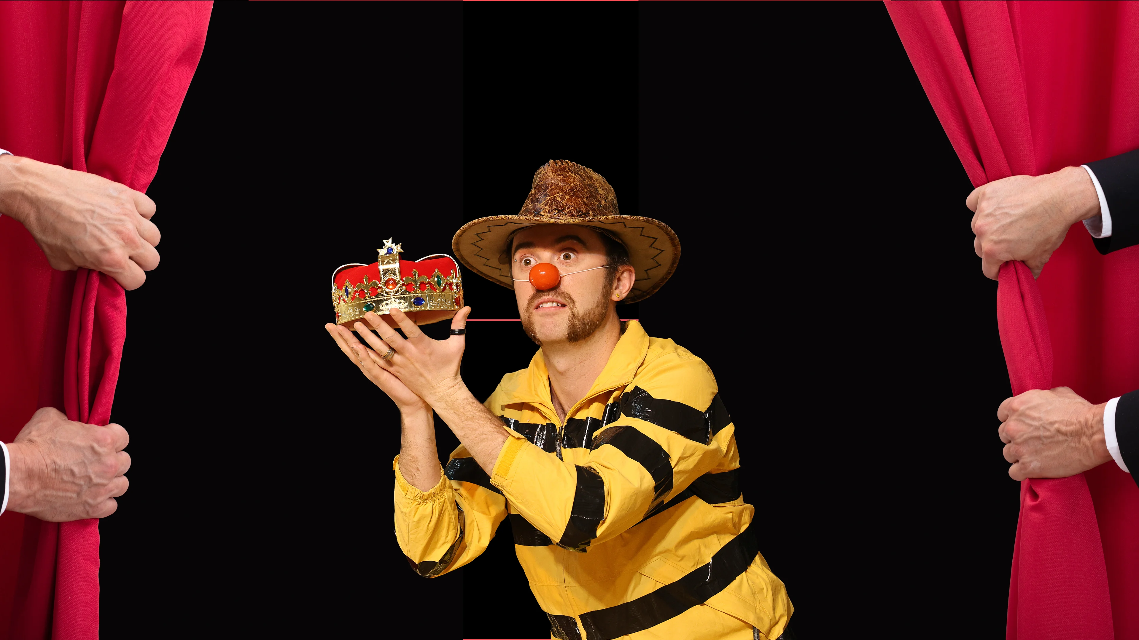 Charlie Jackson with a clown nose holding a crown and wearing a yellow and black striped top and a cowboy hat.