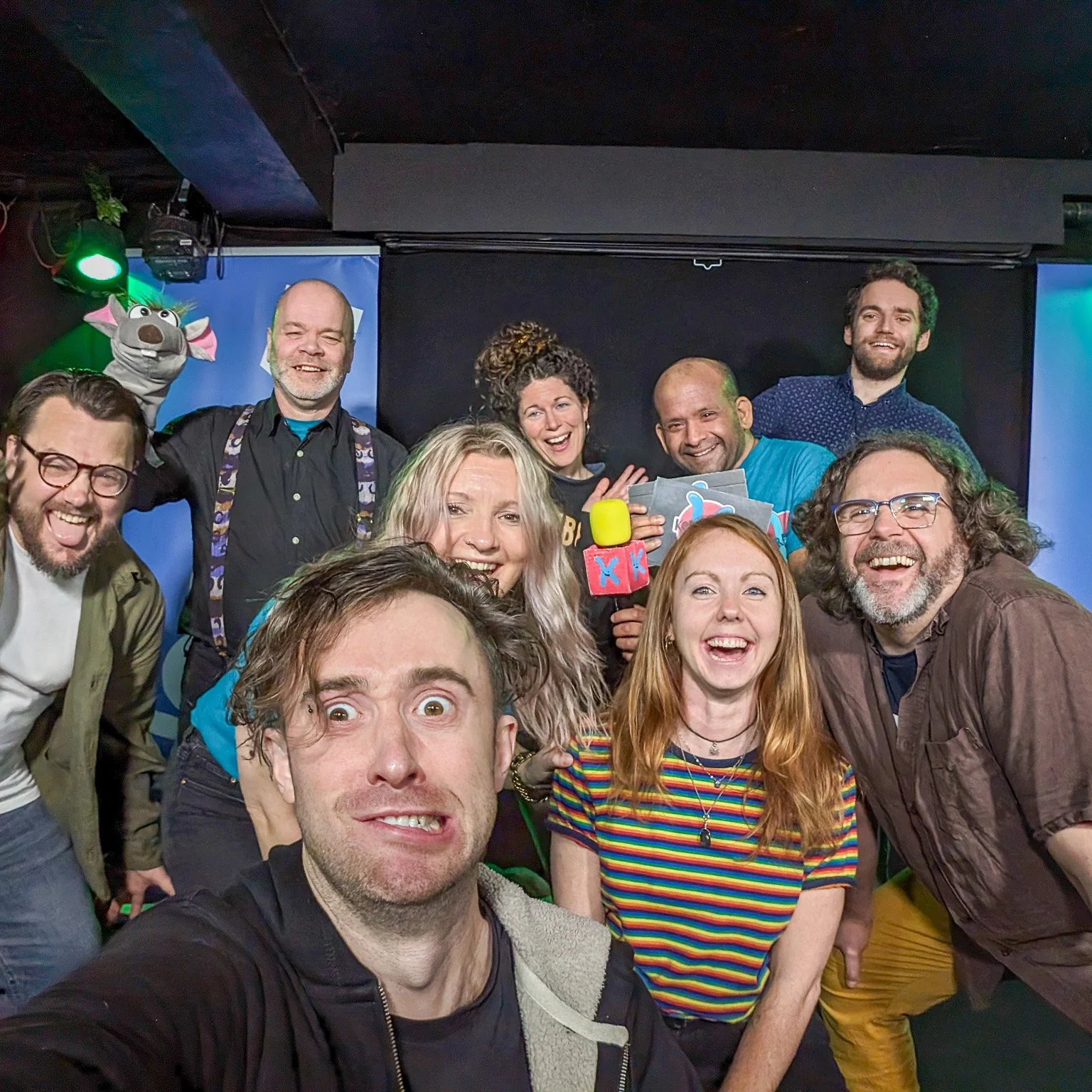 Kerfuffle at RH and friends 2024 Kerfuffle improv comedy team on stage after a show with RH and friends in Feb 2024. At the Hoopla Impro comedy stage in London Bridge. 9 members on kerfuffle posing and waving to the camera